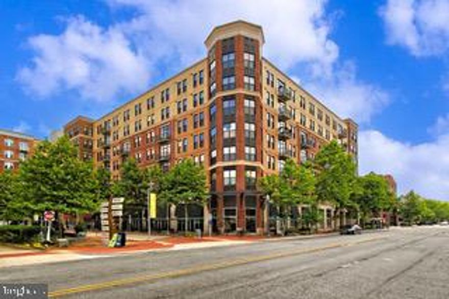 Welcome to The Little City!   Welcome to refined living in the highly sought-after Spectrum Condominium—perfectly positioned in the heart of Falls Church City, one of Northern Virginia’s most charming and walkable communities. This stunning 2-bedroom, 2-bath residence offers the ideal blend of modern design, comfort, and convenience—just steps from everything that makes Falls Church City so special. Inside, you’ll find an open-concept layout filled with natural light, seamlessly connecting the kitchen, dining, and living spaces—perfect for both everyday living and entertaining. The gourmet kitchen features a large center island, sleek cabinetry, and high-end appliances, creating a true focal point of the home. Thoughtful upgrades like crown molding, recessed lighting, and a mix of hardwood flooring and plush carpet elevate the overall feel. The spacious primary suite offers a peaceful retreat with a walk-in closet and a beautifully appointed en-suite bath. A second bedroom and full bath provide flexibility for guests, a home office, or additional living space. Enjoy your morning coffee or unwind in the evening on your private balcony. This residence also includes two assigned garage parking spaces—an exceptional convenience in this prime location. Spectrum residents enjoy an impressive suite of amenities, including concierge service, a fully equipped fitness center, rooftop terrace with grilling area, party room, game room, and library—offering a true lock-and-leave lifestyle. Beyond the building, Falls Church City delivers a lifestyle that is hard to match—known for its small-town charm with big-city accessibility. Enjoy award-winning restaurants, local coffee shops, weekly farmers markets, parks, and community events—all just outside your door. With easy access to Metro, major commuter routes, and both Washington, DC and Tysons Corner, this location is ideal for those seeking connectivity without sacrificing character. This is a rare opportunity to own in one of the DMV’s most desirable communities—where lifestyle, location, and convenience come together seamlessly.