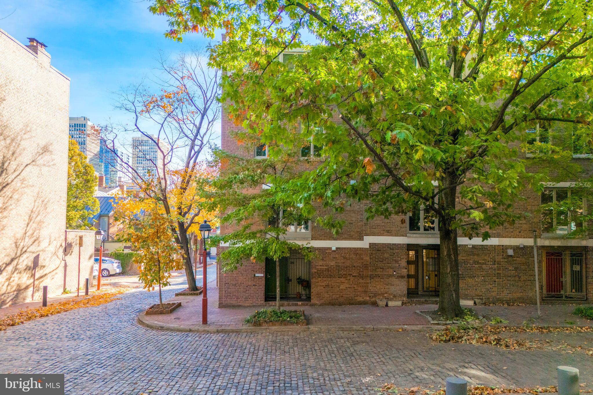 315 Lawrence Court, a stunning modern residence is being offered for sale for the first time in 40 years. Lawrence Court is a quiet cobblestone street lined with trees and design by architects Bower & Fradley in 1970. Enjoy lush views from the oversized windows that bring natural light from all 3 directions in this corner residence. As you enter, you are greeted by an open and inviting floor plan that seamlessly connects all the living spaces. The entry level has a den with a gas fireplace, a mechanical room, half bath, and another room that was used as an office space but could also be a home gym, playroom, or bedroom. The next level has the dramatic living room with 10 ft+ high ceilings, a wood burning fireplace with built ins on either side and french doors overlooking the rear patio. The abutting dining and kitchen area up a few stairs makes for easy entertaining. Some highlights of the kitchen are a Subzero refrigerator, a Wolf stove, Poggenpohl cabinetry, and a Quartz countertop perfect for the culinary enthusiasts. On the next floor there are 2 bedrooms, with one having an ensuite bathroom with a stall shower and a walk in closet, and the other originally 2 bedrooms, now 1 spacious bedroom and a hall full bath with a tub. One the third floor there is the primary bedroom with built ins and an ensuite bathroom with a walk in shower and a large vanity with double sinks. Finally, there is another bedroom on this floor as well. Outside, the patio is perfect for relaxing or hosting gatherings and has access to the parking spot behind the home. There is a transferable 15 year warranty on the brand new roof as well and many newer Anderson windows. Finest location in a historically preserved neighborhood, with enchanting green spaces such as Three Bears Park, Independence Park, and the upcoming 11.5 acre park with the 95 capping project, while being a quick walk away from a myriad of fantastic restaurants, cafes, the Ritz and PFS theaters and only a 15 minute ride to the airport.