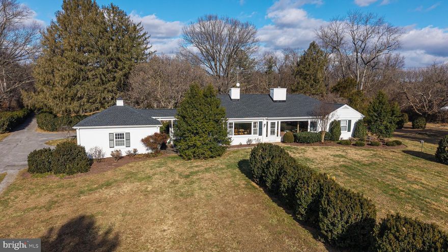200 english box bushes lead you into the Clearing and ring your garden terrace - a terrace with a stunning view of the Blue Ridge Mountains.  The Clearing, a private 11.19 acre parcel with charming guest cottage and house is nestled amongst many larger parcels in Clarke County.  Minutes from the Village of Millwood and historic Burwell Morgan Mill.  The house, built in 1940, has been home to two families -- it has seen its share of hunt teas and glorious occasions.  The interior of much of the house is finished with lovely wormy chestnut custom paneling and cabinetry.  Three stone fireplaces add charm and warmth.  One level living makes this home perfect for entertaining.  A beautiful foyer leads into a formal living room which opens to a comfortable slate floor family room and dining room . Two bedrooms and two and one half baths all on one level.  The views from every window on the south side of this house are breath-taking.  In addition to the main house there is a cute 2 bedroom guest house with fabulous views and a very private location. Open family room with fireplace leads to a charming kitchen.  Excellent rental income or perfect guest cottage.  A four run dog kennel is steps from the house.  Two car garage with small breezeway is just off the kitchen.  Minutes  to Millwood, Boyce and Berryville.  One hour to Dulles airport and one and a half hours to Washington, DC.  Winchester hospital and Shenandoah University 20 minutes.  Upperville and Middleburg right around the corner, 15 minutes.