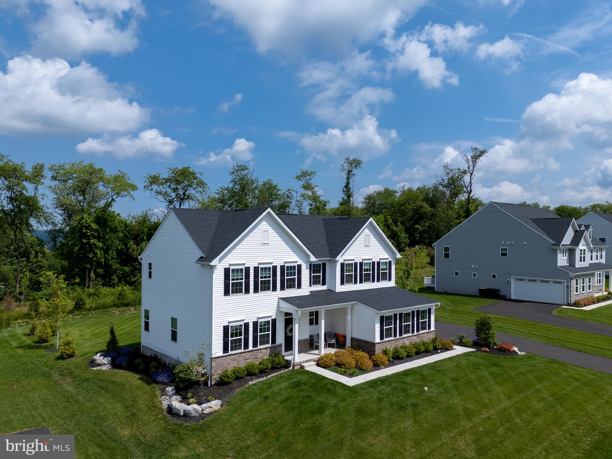 Modern Luxury Meets Everyday Convenience in this Estates at Saucon Valley gem in the highly sought-after SOUTHERN LEHIGH SCHOOL DISTRICT. This home was recently built on one of the most DESIRABLE LOTS with a wooded tree line to the rear. Step inside and feel instantly at home in a light-filled, thoughtfully designed residence featuring wide-plank HARDWOOD FLOORS ON THE MAIN & 2ND FLOORS, an open layout, and timeless neutral finishes. A formal dining room with FRENCH DOORS makes an elegant impression, while the bright living room with GAS FIREPLACE invites cozy gatherings year-round. The heart of the home is a CHEF-WORTHY KITCHEN, outfitted with quartz counters, tile backsplash, OVERSIZED ISLAND, and GE Profile + CAFÉ appliances. The adjacent eat-in area flows seamlessly to a COVERED TREX DECK & beautiful PAVER PATIO with landscape lighting to set the mood. Upstairs, you'll find FOUR SPACIOUS BEDROOMS, including a PRIMARY SUITE with TWO WALK-IN CLOSETS & a spa-inspired bath. Enjoy the convenience of a 2nd floor laundry room. The FINISHED LOWER LEVEL is perfect for a home theater, fitness area and home office workspace. Plus there's a FULL BATH and plenty of storage. Close to parks, Saucon Trail Trail, Saucon Valley Country Club and so much more!