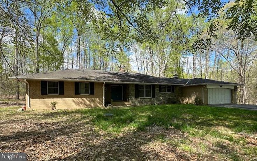 $20,000 PRICE REDUCTION!!  Seller is also offering $17,000 concession to the buyer!!

Welcome to this beautiful 4-bedroom, 2.5-bathroom home nestled on a serene 5-acre wooded lot. With expansive living spaces and a thoughtful layout, this home provides comfort and style for every member of the family. 

As you enter the home, notice the beautiful slate foyer and smooth floor transitions. The large country kitchen features modern appliances with ample counter space plus room for a table. The adjacent dining area is ideal for family meals and large gatherings. The family room, with its wood burning fireplace, offers a perfect spot to relax and overlooks the rear patio. The panoramic sliding doors allow for plenty of natural light as you enjoy the peaceful wooded surroundings. There is also a spacious formal living room just off the foyer.

On the other side of the home, you’ll find the good-sized primary suite with an ensuite bathroom and 2 closets, providing a private retreat. Two additional bedrooms share a full bathroom and offer plenty of space for family or guests.

The lower level, with more than 1,400 finished square feet, has a huge recreation room and the fourth bedroom. You’ll also find the utility room with the whole house water filter, water softener, and boiler. The water heater is part of the boiler system. There is also a water remediation system installed in the basement that spans the entire foundation with multiple sump pumps.

The HVAC is a heat pump with a standalone oil boiler radiator. The heat can automatically switch between the heat pump and the boiler OR the boiler can be run in standalone mode with 4 zones. Cooling is provided in the upper level by the heat pump and by window units in the lower level.
Outside, the beauty of nature surrounds you. The wooded lot provides tranquility and privacy, while the cleared area is ready for your personal touch. Whether you're looking to have horses, goats, or a chicken coop, plant a large garden, or create an outdoor oasis, this versatile space is ideal. With plenty of room for outdoor activities, this home is perfect for anyone who loves nature and enjoys a rural lifestyle.

Located close to local amenities and major highways, this home offers the best of both worlds: peaceful, country living with easy access to everything you need. Don’t miss your chance to own this one-of-a-kind property!