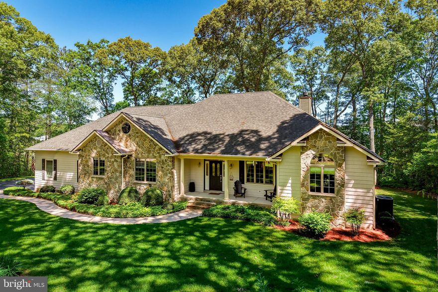 WATER VIEW PRIVACY ON LOVE CREEK– 1.37 Acres of wooded serenity.  Welcome to your dream retreat nestled along the tranquil waters of Love Creek. This picturesque waterfront property offers the perfect blend of privacy, comfort. The front porch offers a broad view of the front yard, featuring mature trees and planted bedding areas. 

This spacious coastal style home features 4 bedrooms and 3 baths. The first-floor owner’s suite is complete with 2 large walk-in closets and a spa-like bath. The screened-in porch features a hot tub and access to the large deck. Make it your private escape for morning coffee, tea and all day relaxation. The main floor also offers a versatile 2nd bedroom currently used as an office for remote work. The third bedroom is spacious for visiting family and friends. 

The large living room features a vaulted ceiling and a massive stone wood burning fireplace with a large mantel. Enter the large deck from the living room. The deck overlooks the large backyard. It features some water views, a fire pit and plenty of space for family entertaining.  The large semi- formal dining area offers plenty of space for family gatherings. 

The large country kitchen is a chef’s delight, featuring custom cabinetry, granite countertops, a generous island with a built-in veggie sink, a wet bar with a built-in sink, and a pantry. The coffee bar area is well-equipped with a sink for making after dinner drinks.

The large laundry room includes a utility sink and is adjacent to the garage. Enter the large 3 car garage with a work bench. Plenty of storage abounds for vehicles, yard equipment and toys! The central vacuum is perfect and convenient for chores and keeping the house neat and tidy.

Upstairs offers a fourth oversized bedroom with a bath and shower. The room offers privacy for your guests. Close the door to the lower level and enjoy a great night of sleep. Leave the slider doors open, let the breeze blow in and wake up to the birds chirping. The upper deck overlooks the spacious yard. There is an extra large attic for storage. The HVAC was recently installed in 2022 and has a separate thermostat control. There is a whole house dehumidifier. The utility costs are low with the De. Electric Co-Op. Anderson Energy Efficient Casement windows keep  your utility expenses low.

The lawn will stay perfectly green year round with irrigation from a separate water well. Enjoy the large fire pit area for relaxing evenings. Use the Blackstone grill and a regular grill to cook dinners for your family gatherings. The house has an ATD security system. The flood lights are great for evening strolls in the yard. 

Visit this spectacular house and fall in love with the privacy and serenity of the large wooded lot. Great for a primary residence or a second-home getaway!