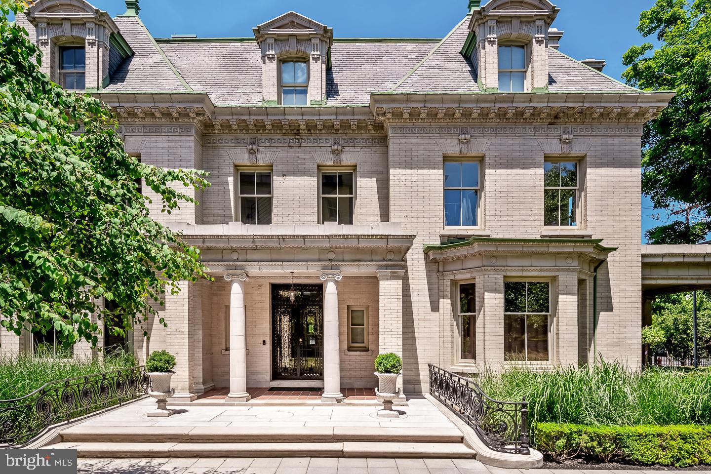 Bathed in natural light, space and history, this charming and stately home in Spruce Hill awaits its new owner. With its commanding presence, the home is located on the corner of Pine Street and 42nd Street. The exterior of this home features a spacious and lush lawn, a large private side porch, shade trees, beautiful perennial plantings, wrought-iron fencing, and reserved on-site parking for residents and guests. Though essentially a private residence, it is part of the 4200 Pine Condominium. Situated in the Penn-Alexander School Catchment, this historic 4 bedroom/3.5 bath home was crafted from a larger mansion. Originally designed by the Philadelphia architect Horace Trumbauer. 4200 Pine is one of the most significant homes in the City of Philadelphia. This elegant historical residence has been meticulously maintained, with extensive plumbing and electrical upgrades in 2011. Features include 4 fabulous floors of luxury, 3.5 baths, the full baths have heated flooring, 9-foot ceilings, 3 working fireplaces, and exposures offering an abundant amount of natural light, intricate woodwork and plasterwork details which include Wedgwood inlaid tiles, and modern interior touches. While the bones of this home remain intact, contemporary touches harmonize seamlessly with original features. The grand porch is original, as are the Mercer tiles. Original wooden floors abound, and pocket doors remain elegantly functional. Additionally central air conditioning has been installed, with the practicality of 2 separate zones. Enter through the magnificent original doors, into the stunning foyer that contains a discreetly placed powder bath. The first floor reveals a recently renovated open-concept space, perfect for family time or entertaining guests. With a living room flowing into a dining area and kitchen, the cook is always included in the conversation. An entertainer's dream floor plan. The kitchen boasts Wolf, Bosch and Miele appliances. Original sets of French doors open onto the enormous porch and outdoor lawn and gardens. A modern floating staircase leads to the second floor. Here, the primary suite features an enormous bed chamber, a magnificent original plaster medallion on the ceiling, a large dressing room with a walk-in cedar closet, tastefully appointed full bath, a remote-controlled gas fireplace, beautiful original details, and exposures on three sides. The 3rd floor contains 2 bedrooms, plus a full bath and Bosch washer and dryer. The cavernous lower level, with an abundance of natural light is the perfect multi-functional space to serve as an office, gym, secondary entertainment space, or other purposes. Additionally, there are five storage spaces to use as needed. This home also boasts, energy-efficient windows throughout and a tankless hot water heater. Though this home is part of the 4200 Pine Condominium, it retains a unique status as it is on half of the original Eishelor family mansion. Owners enjoy the advantages of living in a private residence, landscaped lawns and securely gated courtyard: on-site parking, on-site trash disposal and recycling; a property manager; and an association that covers the roof, exterior, trash and snow removal, and more. A leafy, lively and lovely historic neighborhood is yours to explore. Clark Park and its Farmers’ Market, Jazz and Movies under the stars, the West Philadelphia green trolley line, the Penn-Alexander Catchment, and so much more. Within an easy walk are the local food Co-op Mariposa, Baltimore Avenue’s Restaurant Row, Renata’s, the Bottle Shop, Lil Pop Shop, CVS, and many coffee shops, grocers, restaurants, boutiques, museums, and a movie theatre. The location is in close proximity to HUP, CHOP, PENN, Drexel, Wharton, and University of the Sciences. Additionally, it's very accessible to Rittenhouse Square, 30th Street Station, and the rest of Center City by car, bike, or SEPTA.