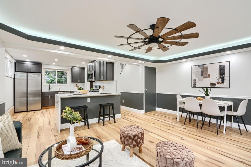 Welcome to 6112 Chinquapin Parkway! This beautifully updated home offers three spacious bedrooms and a fully renovated bathroom upstairs. The main level features an open concept with white oak color floors. The stunning kitchen has been completely remodeled with modern cabinetry, stainless steel appliances, a peninsula with a quartz waterfall countertop. The living and dining area have tray ceilings with built-in lighting. You will love the private deck that backs up to trees—perfect for relaxing or entertaining. The fully finished walk-out basement includes a large rec room, an additional bedroom, and a full bathroom. This move-in ready home is a must-see!