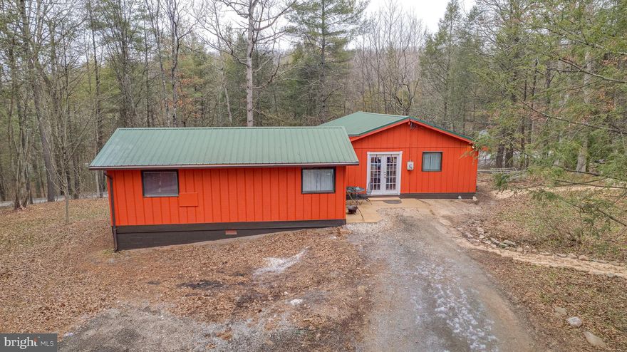 Just listed!! This fully renovated rustic cabin on 5 unrestricted acres checks all the boxes!! Recent updated include a newer metal roof and fully painted/stained both inside and out, newly insulated vaulted ceiling in main room (Kitchen, Dinning Family), and new LVP flooring throughout. The kitchen is outfitted with new granite kitchen counters, center island, pot rack, and stainless steel appliances. Vaulted family room is equipped with a brand new pellet stove and you can access French doors from the family room to the new wrap-around 7x28 deck with new cable wiring. Brand new full bath with standup shower along with 2nd bath with soaking jetted jacuzzi tub and separate shower. Property has multiple sheds and greenhouse for all your outdoors/gardening tools. Hunting allowed, and there is creek access and access to Sleepy Creek WMA. Property boarders Sons of American Revolution park and is private, yet provides easy access to both Berkeley Springs and Martinsburg. You must see for yourself to appreciate. Schedule your showing today!!
