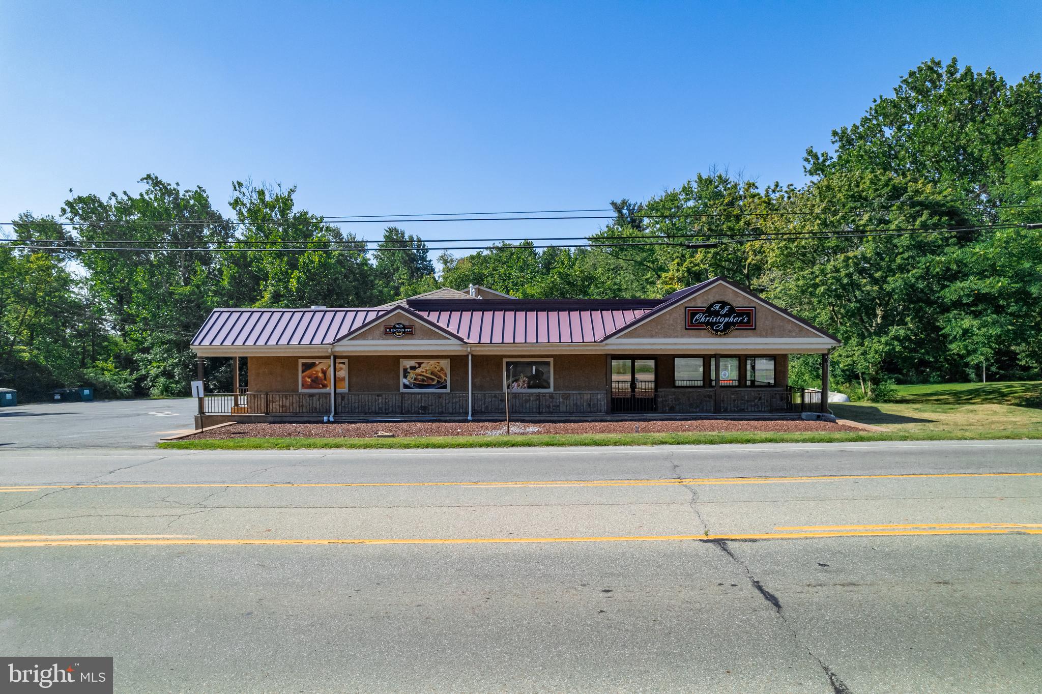Fully Renovated 5,700 SF Commercial Building on 4.46 Acres – Former AJ Christopher’s Bar & Grille | 436’ Frontage on Business Route 30
An exceptional opportunity awaits with this pristine 5,700 square foot commercial building—formerly AJ Christopher’s Bar & Grille—now offered as real estate only. Situated on 4.46 beautifully maintained acres with 436 feet of prime frontage on Business Route 30 (Lincoln Highway), this property offers incredible visibility and versatility, located between Lancaster and King of Prussia, with a daily traffic count of over 32,000 vehicles.
Property Highlights:
Building Size: 5,700 SF, fully renovated in 2016
Lot Size: 4.46 acres with 64 parking spaces
Zoning: Community Service District – allows for a variety of approved uses including retail, apartment building, hotel, restaurant, medical office, daycare, school, professional offices, bank, contractor establishment, fitness center, and more (verify with township)
Seating Capacity: Approx. 140 including indoor and outdoor deck seating
Bar Area: Elegant custom bar with seating for 20, opens to deck overlooking a serene natural setting
Outdoor Features: Beautiful deck with stair access and handicap-accessible ramp
Basement: Full clean basement with loading dock, ideal for storage or operations support
Frontage: 436 feet on heavily trafficked Business Route 30
Loading Docks: Two total – one on each level
Upgrades & Infrastructure:
Two Generac commercial generators (installed 2019) for full backup power
New roof (2020) and newer HVAC system (2019)
Custom walk-in coolers, five-door refrigeration unit
Security camera system
New septic and well system installed by previous owner
Two forcing sink pumps installed in 2021
Water maintained and tested monthly
Renovated restrooms, beautifully updated interior finishes throughout
Surrounding Development:
Minutes from Lockheed Martin, Chester County Airport, and national retailers like Walmart, Wawa, Home Depot, CVS, Penn Medicine, and the new TJ Maxx shipping center currently under construction.
Don’t miss the chance to own this standout property in one of Chester County’s fastest-growing corridors. Whether you envision retail, hospitality, medical, or professional office space, this site is ready to deliver.
Schedule your private tour today!