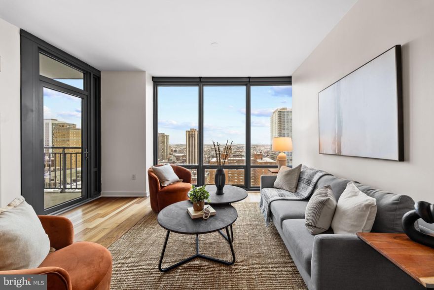 Welcome to a rare opportunity to own a stunning one-bedroom, one-bath residence on the 21st floor of the prestigious MURANO building at 2101 Market Street! This south-facing, 822-square-foot home offers breathtaking panoramic views and is a perfect blend of luxury and convenience. Step into a light-filled living space with floor-to-ceiling windows, showcasing the beauty of the city skyline. The open-concept design seamlessly connects the living and dining areas, creating an ideal space for both relaxing and entertaining. Every detail has been thoughtfully considered, with top-of-the-line upgrades throughout. The chef's kitchen boasts premium stainless steel appliances, custom cabinetry, quartz countertops, and a spacious island with seating. The generously sized bedroom features ample closet space, while the spa-like bathroom is finished with high-end fixtures, a glass-enclosed shower, and modern tile work. Additional highlights include hardwood floors, a private balcony, in-unit laundry, and a deeded parking space for ultimate convenience. Residents of the MURANO enjoy five-star amenities, including a 24-hour concierge, a fitness center, an indoor pool, and a prime location just steps away from Rittenhouse Square, world-class dining, and vibrant cultural destinations. This impeccably upgraded unit is move-in ready and won't last long! Schedule your private tour today to experience elevated city living at its finest.