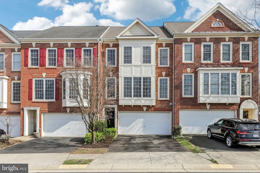 Welcome to this beautiful, well maintained 3-level townhome ready for move-in located in the highly sought-after Stone Ridge community, perfectly tucked away for added privacy while still offering unbeatable convenience! As you enter the home, you are greeted by stunning hardwood floors and a spacious foyer that leads to a light-filled family room featuring dramatic floor-to-ceiling windows and soaring vaulted ceilings. Just above, the elegant dining room overlooks the family room and is beautifully appointed with crown molding, chair rail, shadow boxes, and gleaming hardwood floors—creating the perfect space for entertaining. The bump-out eat-in kitchen is both stylish and functional, offering granite countertops, a gas cooktop with double wall oven, recessed lighting, and hardwood flooring, along with plenty of space for casual dining. As you make your way upstairs, you’ll find a convenient half bath located on the landing, perfectly tucked away from the main living areas for added privacy. The upper level continues with crown molding in the hallway and features a spacious primary suite with vaulted ceilings, a walk-in closet, and a private ensuite bath complete with a double vanity, soaking tub and shower. Two additional generously sized bedrooms, a full hall bath, and a laundry closet with full-size washer and dryer complete the upper level. The lower level offers a cozy rec room with a tiled fireplace, recessed lighting above the fireplace, a half bath, and direct access to the spacious two-car garage. Step outside to a fully fenced backyard with a beautiful paver patio—perfect for relaxing or entertaining. Major updates include hot water heater (2026), dishwasher (2025), washer (2024), HVAC (2020), refrigerator (2019), and a newer roof. Enjoy fantastic community amenities including three pools, a clubhouse, and tot lots, all while ideally located within walking distance to shopping, dining, a library, coffee shops, and just minutes to Stone Ridge II Park & Ride and Dulles Airport. A perfect blend of style, comfort and location – this is one you won't want to miss!