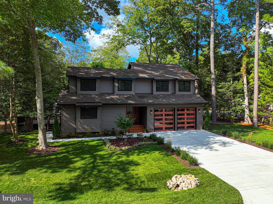 Completely rebuilt from the studs out. Wide open floor plan with with vaulted ceilings give so much drama. Beautiful details in the great room from the custom staircase with contemporary wire spindles and  wood handrails, wood ceiling beam, ceiling fan, and luxury vinyl wide wood like plank flooring. The Gorgeous kitchen has white and wood  contrasting cabinets with stunning quartz counters and backsplash. The huge island adds so much storage and the ability to gather for dining. Industrial  glass pendants with brushed gold hardware coordinate with the gold cabinet pulls.  New Stainless Steel appliances, range hood and cooktop. The primary first floor bedroom  with shiplap accent wall has new carpet and walk-in closet.  The primary bathroom was tiled from floor to ceilings. The glass seem-less shower doors are to die for with  the brushed gold hardware matching the faucets and vanity knobs.  there is also a first floor powder room and laundry room off of the 1 1/2 car garage.  The second floor has 3 very spacious bedrooms , new carpet, ceiling fans and  2 custom tiled  full bathroom.   All electric and plumber is new and brought up to   code. Every new window and door has been finished off with custom moldings.
The exterior of the home is brand new as well. Roof, siding, gutters, lighting, landscaping, all new! Trees were removed to add the beautiful sodded front and side yards . The most impressive addition is the  concrete driveway and sidewalk . The new driveway adds parking for 4-6 cars. The solid wood front door is stained to match the contemporary windowed garage doors. 2 zoned HVAC and wired for cable.