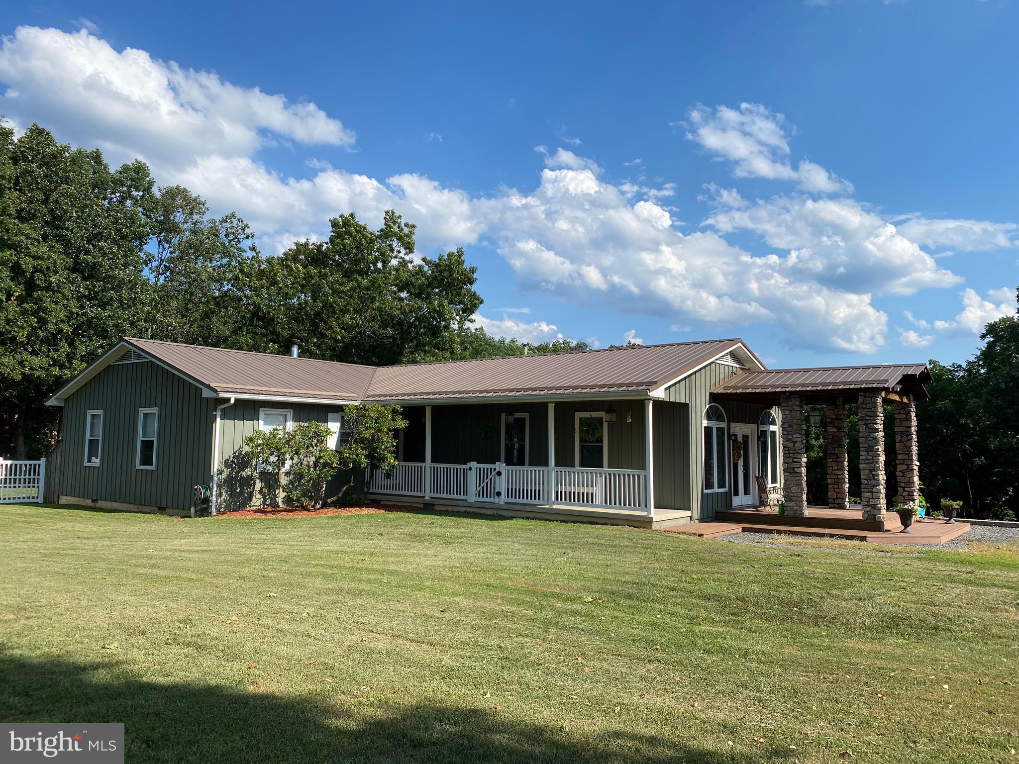 On the outskirts of town back a blue stone road that many don't know exists sits a ranch style home with all the feelings of a Tuscan lodge. With just over 1 acre this property feels like it's much larger. The back yard is fully fenced and has a beautiful patio with a tree house and swing set for the kids. Inside there is plenty of room for everyone with 4 bedrooms and 3 baths. The private primary has a massive walk in closet, beautiful stone mantel for the fireplace. The on suite bath has a duel sided fireplace and heated flooring. The Living room has another beautiful stone mantel with a wood burning fireplace and built in bookshelves. Unwinding in the evening is so relaxing while the sun pours in through the extra large windows in the den.