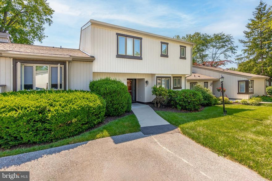 Welcome to 287 Devon Way, a delightful 2-bedroom, 2.5-bath townhouse situated in the highly sought-after Hershey's Mill community in West Chester. This lovely home begins with a welcoming foyer that continues into the eat-in kitchen, featuring granite countertops, a durable laminate floor, and a spacious pantry. Adjacent to the kitchen is a dining room, complete with a sliding door that opens to a private patio, ideal for al fresco dining and entertaining. The inviting living room boasts a cozy fireplace, a vaulted ceiling, and another sliding door leading to the patio, enhancing the indoor-outdoor living experience. A convenient laundry room and a powder room complete the main level. Ascend to the upper level where the primary bedroom awaits, offering a serene retreat with a walk-in closet and a sliding door that opens to a private balcony. The en-suite bathroom features a tile floor. The second bedroom includes attic access and its own en-suite bathroom with a tile floor and a tub/shower combination. Additional highlights of this home include casement windows, exterior lighting, a detached one-car garage, and beautifully maintained landscaping. Notable updates include new cement walkways to the house installed in 2022, a new roof in 2023, and the completion of the Village "wood restoration project" in 2024. With these improvements, no significant Village capital improvements should be necessary in the near future. As a resident of Hershey's Mill, a vibrant 55+ community, you'll have access to a wealth of amenities including a golf course, tennis courts, a swimming pool, and scenic walking trails. Plus, you'll enjoy a prime location close to all that West Chester has to offer. Don't miss the chance to make 287 Devon Way your new home!