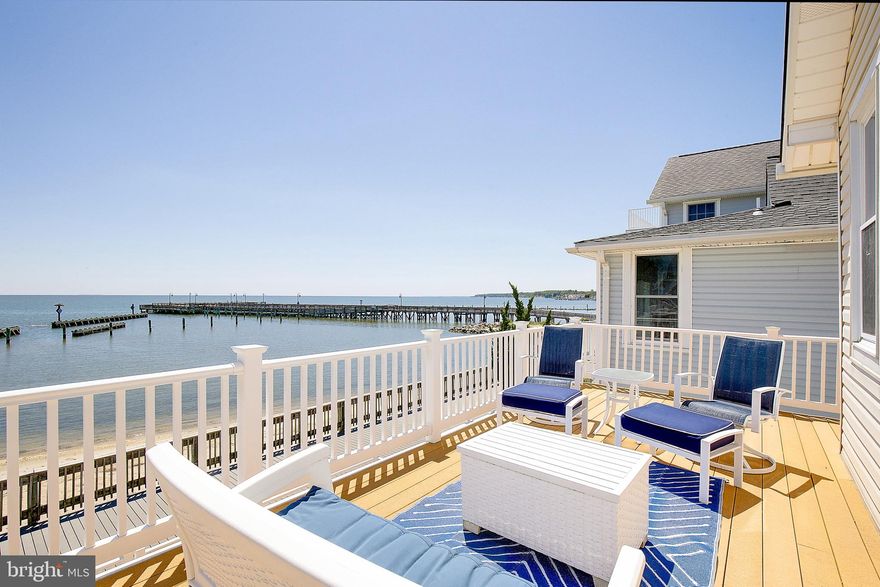 Luxury Waterfront Living in the Heart of North Beach! Wake up to million-dollar views of the Chesapeake Bay in this stunning, fully furnished waterfront retreat perfectly positioned in the heart of North Beach. Offering the ideal blend of coastal relaxation and small-town convenience, this exceptional home is just steps from local restaurants, the beach, ice cream shops, a wine store, boutiques, and the beloved North Beach boardwalk—making every day feel like a vacation. With plenty of off-street parking and multiple outdoor living spaces, this home is designed for entertaining and soaking in the waterfront lifestyle. Enjoy breathtaking sunrises and panoramic bay views from the expansive upper and lower waterside decks, or unwind on the street-side deck after a day at the beach. The beautifully updated kitchen is a showstopper, featuring a huge center island, Corian countertops, stainless steel appliances, and an open floor plan perfect for gathering family and friends. Just off the kitchen, you’ll find a convenient laundry room and half bath. The spacious dining and living room combination offers abundant table space for entertaining, while the large family room opens directly onto the expansive deck overlooking the Bay—bringing the outdoors in.
The main-level primary suite offers a private retreat complete with a double vanity, custom tiled walk-in shower, and spacious walk-in closet. Upstairs, two additional bedrooms and a full bath provide ample accommodations for guests and family. One bedroom enjoys direct access to the upper deck—perfect for morning coffee, reading, sunbathing, or simply taking in the endless water views. The second bedroom is designed to comfortably sleep a crowd with a queen bed plus bunk beds featuring a queen below and twin above. A charming wooden staircase leads to a whimsical loft space—perfect for kids to play board games, hang out, or create unforgettable sleepover memories. Sold fully furnished and complete with kitchenware and décor, this property is truly turnkey—ideal as a full-time residence, fabulous second home, or income-producing short-term rental/Airbnb that comfortably sleeps 8–10 guests. Enjoy the charm of a small waterfront town with excellent schools, all while being within an easy commute to Washington, D.C., Joint Base Andrews and Northern Virginia. Whether you're searching for a peaceful waterfront escape, a place to gather generations of family, or an investment opportunity, this North Beach gem offers the very best of Chesapeake Bay living.