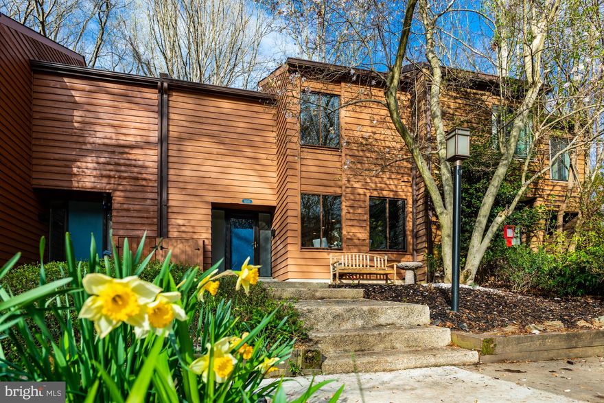 Serene upgraded woodland retreat!  Directly overlooks 72-acres of tranquil treelined parkland! -- Gorgeous newly refinished HARDWOOD floors on main and upper levels -- Newly upgraded kitchen granite counters, breakfast bar, custom tile backsplash, recessed lighting, flooring -- enjoy 3 comfortable bedrooms and  3.5 updated baths -- Master suite with private bath, walk-in closet, and dressing area -- ***Master bedroom, 2nd bedroom, Living Room, AND walkout lower-level family room ALL directly overlook dozens of acres of mature trees*** -- Brand new sliding glass doors on main and lower levels -- new interior paint and exterior stain -- WALKOUT lower level opens to lovely spacious hardscaped patio and fenced rear yard nestled by nature, perfect for relaxing or entertaining! -- Nearly 2,200 square feet on 3 levels -- Flexible lower-level floor plan has potential for in-law/guest suite.  -- Excellent Reston location:  Across from pool, tennis, tot-lot & trails -- backing directly to Walker Nature Center -- and convenient to Silver Line Metro!