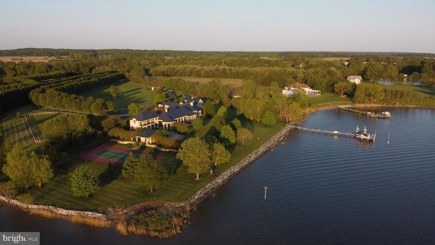 This custom designed old-world country style estate is situated on a spectacular point of land on the Wye River.  Built by Pyramid Builders in 2009, the  Wye Estate  is one of the finest waterfront estates available in the region.  The home is situated perfectly on the nearly 14 acres of manicured grounds and includes a tennis court, saltwater pool with pool house, resort quality outdoor spaces, Amish built barn with 3 stables, 6 acre fenced paddock and a protected deep-water pier.  With reclaimed wood floors throughout, the finest fit and finish, ultra-energy efficient systems, a warm open floor plan and state of the art technology, this one of a kind home is an exquisite blend of old-world charm and modern-day luxury.