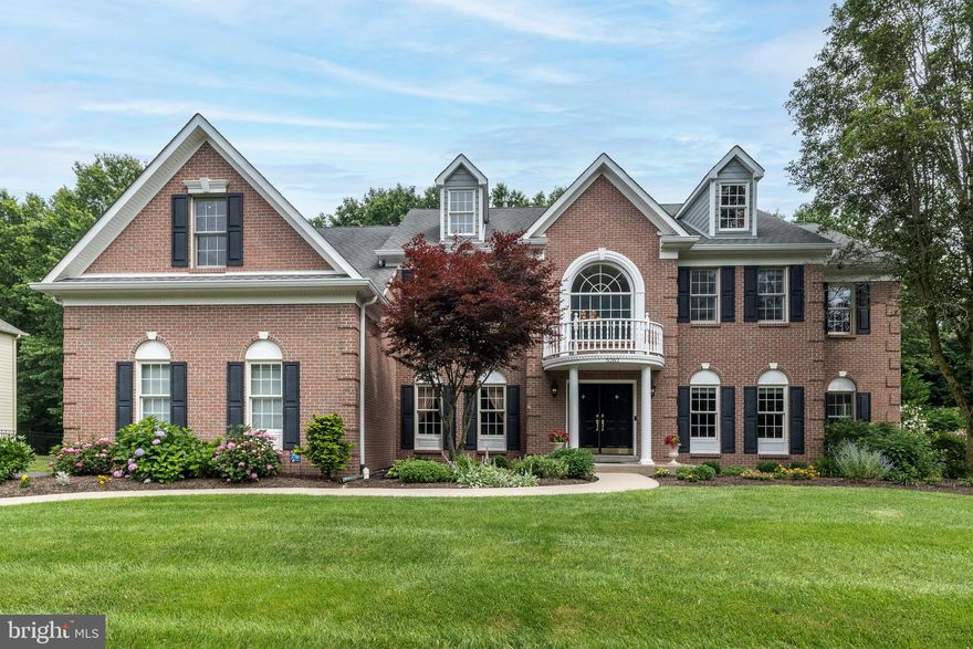 Stately Richmond Federal Model by David Cutler — This meticulously maintained 5-bedroom, 3.5-bath home showcases timeless elegance and modern comfort in the sought-after community of The Reserve at Holicong. Featuring 9-foot ceilings on both the first and second floors, detailed millwork, and gleaming hardwood floors throughout most of the main level, this residence radiates pride of ownership.
The heart of the home is a gourmet kitchen with a sun-filled breakfast area and stunning wall of windows that let in an abundance of natural light. All this overlooks a private, fenced, park-like backyard. Enjoy outdoor living with a paver patio surrounded by lush plantings and fish pond. The stunning gourmet kitchen flows seamlessly into the spacious family room with plantation shutters and a dramatic floor-to-ceiling brick fireplace — perfect for cozy gatherings.
Ideal for entertaining, the inviting formal dining room welcomes guests to linger, while the living room is well used and enjoyed as a game room. A bright first-floor study offers the perfect work-from-home space. Both front and rear staircases add convenience and architectural charm.
Upstairs, the luxurious primary suite is a true sanctuary with tray ceiling, sitting area, abundant closet space, and a spa-like bath to melt the day away. Four additional bedrooms include a private en-suite, Jack & Jill, and ample storage. All bathrooms have been recently and beautifully renovated.
The finished basement includes a home theater, dog wash station, and plenty of storage. The 3-car side-entry garage features epoxy floors and finished walls. Enjoy the changing seasons with perennial blooms and a peaceful backyard oasis. Some of the highlights include a whole house generator, all newer Kitchen appliances (2019) gas cooktop (2025), patio just resanded, driveway just seal coated, new carpet throughout 2nd level, new water heater (2024) & 2 zone heating/air (2023).  All within top-rated schools and a friendly, established neighborhood — this home is truly special & move-in ready!