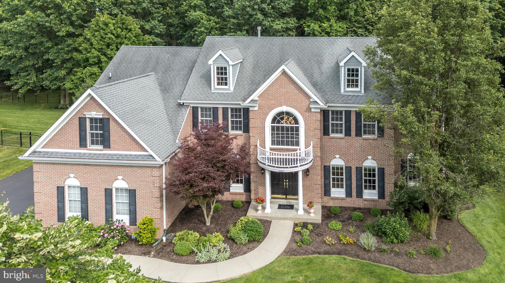 Stately Richmond Federal Model by David Cutler — This meticulously maintained 5-bedroom, 3.5-bath home showcases timeless elegance and modern comfort in the sought-after community of The Reserve at Holicong. Featuring 9-foot ceilings on both the first and second floors, detailed millwork, and gleaming hardwood floors throughout most of the main level, this residence radiates pride of ownership.
The heart of the home is a gourmet kitchen with a sun-filled breakfast area and stunning wall of windows that let in an abundance of natural light. All this overlooks a private, fenced, park-like backyard. Enjoy outdoor living with a paver patio surrounded by lush plantings and tranquil fish pond. The stunning gourmet kitchen flows seamlessly into the spacious family room with plantation shutters and a dramatic floor-to-ceiling brick fireplace — perfect for cozy gatherings.
Ideal for entertaining, the inviting formal dining room welcomes guests to linger, while the living room is well used and enjoyed as a game room. A bright first-floor study offers the perfect work-from-home space. Both front and rear staircases add convenience and architectural charm.
Upstairs, the luxurious primary suite is a true sanctuary with tray ceiling, sitting area, abundant closet space, and a spa-like bath to melt the day away. Four additional bedrooms include a private en-suite, Jack & Jill, and ample storage. All bathrooms have been recently and beautifully renovated.
The finished basement includes a home theater, dog wash station, and plenty of storage. The 3-car side-entry garage features epoxy floors and finished walls. Enjoy the changing seasons with perennial blooms and a peaceful backyard oasis. Some of the highlights include a whole house generator, all newer Kitchen appliances (2019) gas cooktop (2025), patio just resanded, driveway just seal coated, new carpet throughout 2nd level, new water heater (2024) & 2 zone heating/air (2023). All within top-rated schools and a friendly, established neighborhood — this home is truly special & move-in ready!