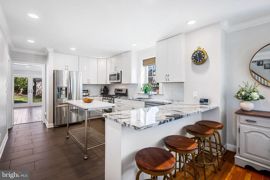 Strum your six-string on your front porch swing at this oh-so-lovely Anneslie colonial. Expanded, improved, and updated with plush amenities and craftsmanship. Need an open floor plan on the main level? Check. Need a main level bedroom and full bath? Check. Need a huge family room with pantry (and access to that full bath)? Check. Need a gourmet kitchen with breakfast bar seating, tons of storage, and updated appliances? Check.  Smell those crustaceans beginning to boil (bubble bubble bubble) and find your shaker of salt because you are HOME. You'll never outgrow this five-bedroom, three-full-bath home and it's main floor family room and finished lower level. And everyone loves Anneslie with its walkability to shops, restaurants, banks, the hardware store, and more. But let's go back to the house--Huge primary suite on the second level features wood floors, lots of windows, walk-in closet, and a full bath with two sinks, separate shower, and a free-standing soaking tub. Second floor laundry room is the size of a small bedroom and easily fits full-sized side by side washer and dryer, utility sink, drying racks, and shelving for storage. Three additional bedrooms on the second level and another full bath.  Perfect level yard. Patio, too. Walk to local schools.