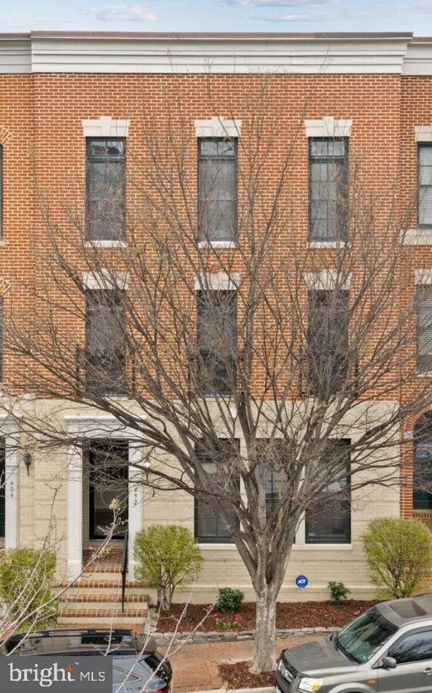 Welcome to this beautiful traditional Brownstone townhouse tucked along a peaceful, tree-lined street with a charming, old-town feel, just steps from the marina and town center. Offering over 3,000 square feet across three fully above-grade levels, this light-filled home combines space, flexibility, and modern updates.

The entry level features a welcoming foyer, a spacious third bedroom with a full-size window and closet, a full bath, and an expansive media/recreation room spanning the entire rear of the home. The space flows seamlessly to the two-car garage, complete with newly finished flooring and freshly painted walls and trim, plus two additional driveway parking spaces.

The main level showcases an open-concept layout ideal for everyday living and entertaining. The kitchen is fully updated with brand new stainless steel GE appliances, including a refrigerator with door icemaker, double wall oven with top convection oven, gas  cooktop, dishwasher, and built-in microwave. The kitchen opens to a large family room with a gas fireplace and access to an oversized terrace—perfect for outdoor enjoyment. A formal living and dining area, along with a convenient half bath, complete this level.

Upstairs, the bedroom level offers two generously sized primary suites, each with its own full bath, ample closet space, and abundant natural light from large windows.

Located in the sought-after Belmont Bay waterfront community, residents enjoy proximity to the Occoquan River, marina, and nearby shops. Convenient access to the VRE and just a short drive to historic Occoquan adds to the appeal of this exceptional home.