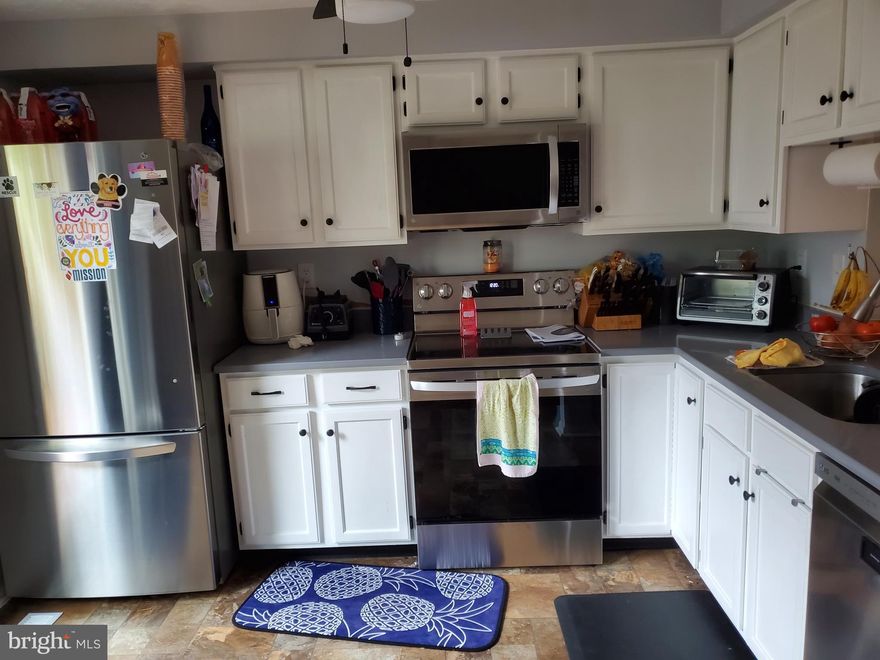 Welcome home to this recently updated 2 bed, 1.5 bath townhome in Woodbridge center. Enter the front door and you're greeted with a spacious living room and large coat closet. In the rear of the house, you will find the kitchen featuring a new quartz countertop (2020) and new stainless steel LG appliances (2020).  Step through the sliding door and onto the back deck, a great space for relaxing and summertime grilling. As you head upstairs, you will find 2 large bedrooms with a recently renovated jack and jill full bathroom. New LifeProof flooring (2020) and an updated vanity and light fixture (2020) just added last year. In the primary bedroom, you'll find two closets, a new ceiling fan (2020), and a makeup vanity area, complete with crown molding. The rear bedroom features a full-wall length closet and ceiling fan.  The finished basement provides storage, a recently renovated half bath, the laundry room and HVAC, and a space perfect for hang outs. The built in bookshelves and storage closet under the steps are an added bonus. The basement is completed by a sliding door, leading you out to your fenced in backyard, complete with a stone pathway to the rear gate. Blinds and curtain rods are staying.