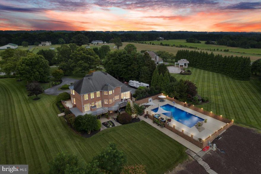 Absolutely spectacular 1.63 acre property with SUPERIOR views of the Patuxent River. Arguably the finest property along the Patuxent River and complimented by the community of Buena Vista on the Patuxent, no HOA.  The community has a deeded boat ramp. This home is nestled amongst thoughtfully chosen, beautiful, and mature landscaping, the grounds of this property are unsurpassed and serviced by a sprinkler system. Huntingtown High and Plum Point school districts.    

This summer enjoy the beautifully landscaped front and backyard, in-ground, and waterside 25x50ft pool.
Relax with a morning coffee in the large screen porch or the covered patio. 
Parking is made easy with a large paved circular driveway and parking pad. The oversized 4 car detached garage also includes an electric vehicle charging station. Custom waterfront all brick home has amazing Sunset views of the tranquil river from every room. Enjoy an extended pier with 4-foot MLW, and a TWO boat houses to secure water toys and fishing gear, and a 20,000 lb boat lift. The 150-foot of shoreline is secured by a fiberglass bulkhead. 

Enter through double-cut glass doors to the two-story foyer and sweeping curved stairway. 
The open-flowing main level offers Chefs Kitchen, room table space, and a living room. The living room offers a gas fireplace and a coffered ceiling. Wide plank oak hardwood floors and granite floors flow out under your feet to the stunning water views from the newly installed windows and doors.  To complete the main level, the room just off of the living can be used as an office, music room, or playroom and has a dome ceiling.

The Chefs Kitchen offers “dueling” sinks and dishwashers for easy quick clean-up after your summer parties. Enjoy the oversized island with a quartz waterfall top. The kitchen has a Butler’s pantry and an additional pantry. Upgraded Stainless Steel Appliances including the drawer Microwave, a warming drawer, double Gas Oven, 6-burner gas stove, wine fridge, instant hot water dispenser, stand-alone ice maker, coffee/wine bar with another 3rd sink, floating shelves, and this all Complimented by a separate dining area and dining room. 
Host an evening soiree and enjoy incredible sunsets from the large wrap-around trex deck. 
The owner's suite offers three walk-in closets, views of Patuxent from the room, tray ceilings, and the owner's bathroom all thoughtfully organized with an octagon ceiling and heated floors. The main closet, offers custom shelving, tray ceilings, an island with granite, make-up table, and a seated bay window.

3 new HVAC systems installed 2022. House was built with a fire sprinkler system.
Secondary bedrooms offer an ensuite bathroom, dual closets, and water views. 
Head down to the lower level for a movie theater room, a large riverside bedroom with a full spacious bathroom. Tax records are incorrect built in 1998. The home has been fully renovated since.