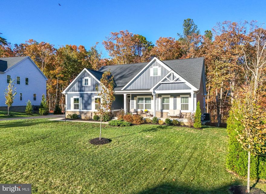 Anchored in the ​luxurious gated lake and golf community of Fawn Lake​ in Fredericksburg, Virginia, this Gorgeous nearly new Dream Home offers ​a modern​, warm and inviting atmosphere ​throughout.
​
Beautifully designed, this ​Modern Rancher built in 2022, boasts ​main level living on a​ flowing open floor plan ideal for​ casual, everyday living​, and entertaining​. 

​At the center of the home is a spacious ​Family ​Room ​that flows seamlessly to an impressive ​Gourmet ​Kitchen featuring a massive island, quartz countertops, double ovens, ​tile backsplash, and a large pantry, perfectly suited for both everyday living and entertaining. The ​adjoining Sunroom flooded with brilliant sunlight, serves as an ideal Dining​ Room. Sliding doors provide easy access to a​n inviting covered porch, perfect for indoor-outdoor gatherings. 
​A quiet retreat, the main level Owner’s Suite with ​private access ​outdoors to the serene covered ​porch, features a beautiful light-filled Spa Bath with dual vanities and tile shower.​ ​Double walk-in closets​ offer plenty of wardrobe ​storage. 

Two additional gracious Bedrooms with walk-in closets share a beautiful Full Bath.
The convenient main-level Laundry Room provides everyday ease.

​Expanding the living space, the amazing walk-out lower level features a massive Recreation Room, which provides unlimited entertainment possibilities. A huge Bedroom with an adjoining Full Bath ​offers comfortable ​extended living for Guests. ​ Glass sliding doors provide direct access to an inviting ​Flagstone patio overlooking the private backyard abutting to a wooded conservation area​.
​ 
​The serene natural backdrop makes outdoor living​ just as special​. Exceptional privacy, peaceful moments and effortless entertaining on the covered rear porch ​can be enjoyed year-round. 
​This turn-key Home is nestled on .40 acres at the end of a quiet​ cul-de-sac, ​near the Fawn Lake Marina​! Take daily strolls or bike rides along the nearby trails ​to​ savor the beautiful sights and sounds of nature​, or meet friends​ at the marina. Imagine​ kayaking, ​paddleboarding, fishing, swimming and breathtaking sunsets​ only steps from your front door! 

Enjoy the exceptional ​Fawn Lake lifestyle and live with ease in this nearly new turn-key home, expertly crafted with energy efficient materials such as a high efficiency HVAC, low maintenance ​Hardi-Plank siding and stone exterior finishes.​  Here you can downsize your home, while elevating your lifestyle!​ Come experience the Fawn Lake Lifestyle and start enjoying our unique way of life!
​
The beautiful luxury and vibrant Fawn Lake Community offers amazing amenities such as a boating recreational lake, sandy beach, an Arnold Palmer designed Golf Course, tennis courts, baseball and soccer fields, dog park, volleyball courts, walking trails, Community ClubHouse, marina, fitness center, restaurants, Country Club, playgrounds, and so much more! Plus with an array of clubs, groups and daily activities, you will have plenty of opportunities to join the social scene, make new friends and remain active all year-round!
Located in the countryside near the town of Fredericksburg, surrounded by park lands and only a few miles to the farm market, wineries, and award winning breweries! Conveniently located to shopping, restaurants, top-rated Riverbend District schools and I-95!​  
Discover refined living in the prestigious lake and golf community of Fawn Lake.