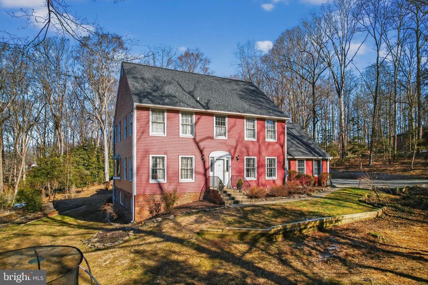 Welcome to this unique 5 bedroom, 3.5 bath Colonial home in Ferry Landing Woods Community.
Over 3 acres of peaceful grounds with a natural masterpiece backyard featuring a picturesque pond with colorful koi fish. 
Entertain in style within the spacious dining room, ideal for hosting intimate meals or grand gatherings. The living room, a gorgeous gathering space, features soaring high ceilings with skylights and uniquely shaped windows that brighten the room and beautifully balance it with a cozy rustic feeling.  At the heart of the home, you'll find a huge chef-level kitchen, perfectly designed for a large scale, seamless cooking and  entertaining. It features a professional-grade gas range with an integrated hibachi griddle plate and a sleek built-in refrigerator for a truly seamless design. This home features a convenient main-level office, perfect for remote work.
The upper level has 4 bedroom with the primary suite designed for ultimate relaxation with newly renovated en-suite bath, features a deep soaking tub and an updated shower, build-in dressing room, and a private deck to enjoy quiet mornings. In additional full bathroom serves the other bedrooms.
The finished basement adds incredible value with a spacious game room with full bar, a dedicated workshop, and additional bedroom provides the perfect guest suite.
The property has been meticulously upgraded including a new septic in 2023, new HVAC in 2024, partial new roof and siding in 2025, new update appliances of washer, dryer, and dishwasher. New well pump and water softener. New front/storm door. Freshly painted throughout, and unified two-key doorknob system. Welcome Home.
Perfectly located for privacy yet easy access to DC and Baltimore via I-95 and Rt. 295.