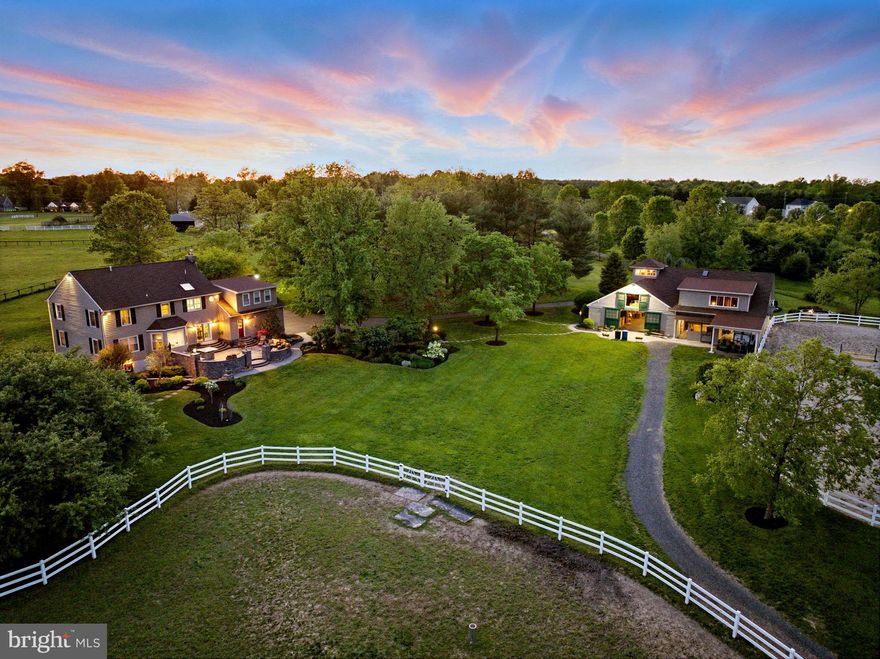 Welcome to Brookview Farm, an exceptional equestrian estate nestled on over 13 picturesque acres in the heart of historic Bucks County. This meticulously maintained property offers a rare blend of luxury, functionality, and income-generating potential within a private, serene setting just minutes from top-tier amenities, shopping, and dining. The elegant, updated residence features a newly added master suite complete with a luxurious master bathroom, a custom walk-in closet with built-in cabinetry, and stunning design details throughout. The home boasts granite countertops, hardwood flooring, and new Andersen windows, blending timeless elegance with modern convenience. Every inch has been thoughtfully cared for, including monthly pest control, to ensure a home of exceptional quality and comfort. Step outside to your private oasis, where a hardscape patio with a fully equipped outdoor kitchen, large gas fire pit, outdoor television, and professionally designed landscaping await. Bluestone walkways, mature trees, and well-manicured garden beds create an idyllic space for entertaining or relaxing. For equestrian enthusiasts, the property offers a state-of-the-art 7-stall barn, complete with a tack room featuring a kitchenette and restroom, and an overhang measuring approximately 24x36 for covered convenience.  There is also a generously sized outdoor sand riding arena, just steps away from the barn.  The estate includes 4 fenced pastures, each with run-in shelters and automatic waterers, as well as a sprinkler system for the grounds. Horse boarding generates a steady income, making this property a savvy investment as well as a dream home. Practicality meets luxury with a backup generator, which ensures uninterrupted power to both the home and barn. The property qualifies for Bucks County's ACT 319 agricultural tax benefits, significantly reducing property taxes while preserving its natural beauty. Beyond the gates, you'll find an ideal location: Warrington Township parks, Delaware Valley University, and top-rated Central Bucks South High School are all within easy reach. Despite its unmatched privacy, the estate is just minutes from bustling amenities, providing the best of both worlds. A charming creek winds through the property, further enhancing the tranquility of this one-of-a-kind estate. Brookview Farm is more than a home—it is a legacy property where elegance and functionality combine with the timeless appeal of country living.