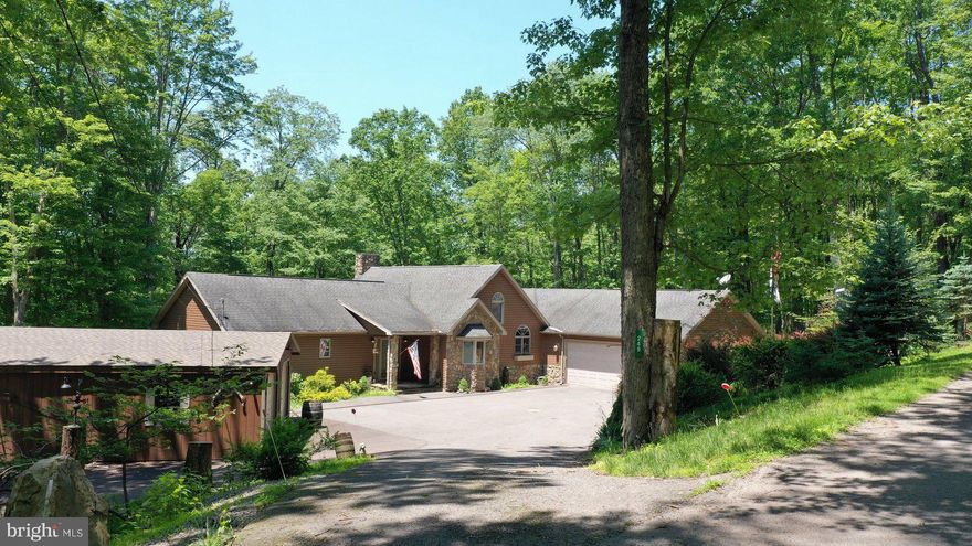 *PRICE ADJUSTMENT* Charming Craftsman Retreat in the Premier Alpine Lake Resort! Nestled in the heart of a sought-after lake resort community, this beautifully crafted seven-bedroom/5 full baths home blends timeless design with modern comfort in a peaceful lake community. Included is a additional lot adjacent to the  right side that gives you plenty of privacy.  This would make a GREAT INVESTMENT PROPERTY! Use for weddings, re-unions, rentals etc. With rich wood accents, detailed trim, and a welcoming front porch, the home exudes timeless character from the moment you arrive. Every corner reflects quality and character. The spacious primary en-suite located on the main level offer a private retreat designed for comfort and relaxation. Featuring a generous bedroom layout, the serene space includes a beautifully appointed attached bath with dual vanities, a walk-in shower, a large walk-in closet adds convenience and functionality. Enjoy open-concept spacious living, a gourmet kitchen, breakfast bar and spacious bedrooms perfect for family and guests. Relax and enjoy the cozy stone fireplace-ideal for gatherings large or small in the great room. The fully finished lower level offers additional living space perfect for relaxation and entertaining. Featuring a spacious family room, kitchenette and bar area designed with both style and convenience in mind. Complete with custom cabinetry, a full fridge, dishwasher, sink and ample counter space. It's ideal for preparing snacks, drinks or casual meals. The lower level offers seating for guests and a welcoming atmosphere for game nights, movie marathons, or weekend gatherings. Whether you're hosting or unwinding, this space adds a fun, functional touch to the finished lower level. The bedrooms are generously sized, offering privacy and comfort for family and guests alike. There is a 2nd laundry room, storage room, 3 full baths, and several storage areas. This home offers two dedicated office spaces designed for focus and productivity. With ample natural light, and a quiet separation from the main living areas, each office provides a comfortable and professional environment. High Speed Fiber Optic Internet ensures reliable, lightning-fast connectivity-making virtual meetings, streaming, and multitasking effortless. Relax on the spacious back and lower decks with a view of the golf course and the natural beauty all around you. This home offers an attached 2 car garage and also a detached 2 car garage for your lake toys and more.  Enjoy the fire-pit area, or take a short stroll to the lodge and enjoy the indoor heated pool, restaurant/lounge, fitness room, 18 hole golf course & miniature golf. Enjoy Alpine Lakes many amenities that include a sandy beach area, kayaking, canoeing, tennis/pickle ball, basketball courts, boat house, boat ramp for installing your kayak, canoe, paddle boat or fishing boat. Hike/bike the many trails throughout Alpine Lake, also feel safe with 24/7 security. Whether you are entertaining, vacationing, or calling it home year-round, this one-of-a-kind property is a true lake retreat that offers the perfect balance of nature, comfort and style. Call to set up a viewing of this Awesome Property...