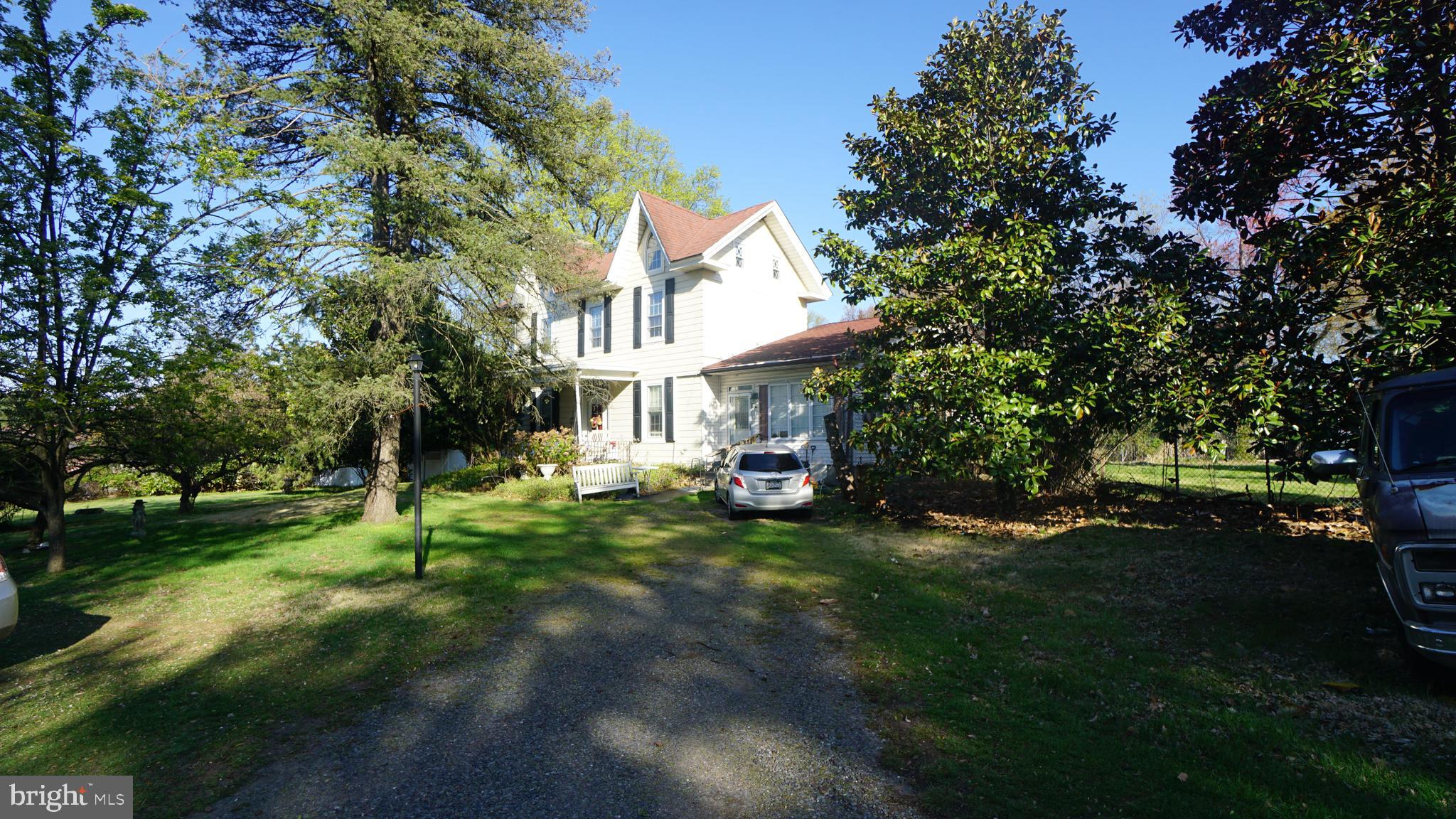 A large, park-like setting with old-world charm, the existing home is a four-bedroom, two-bath, 2,896-square-foot residence. The house needs updating—detached 2-car garage, two storage sheds on the grounds. The possibilities for this property are endless—214' x 336' 1.6 Acre lot: possible subdivision or commercial use. The grounds have existing peach, apple, cherry, and pear trees. A chance to bring one of the town's lost gems back to life, or start with your blank canvas.