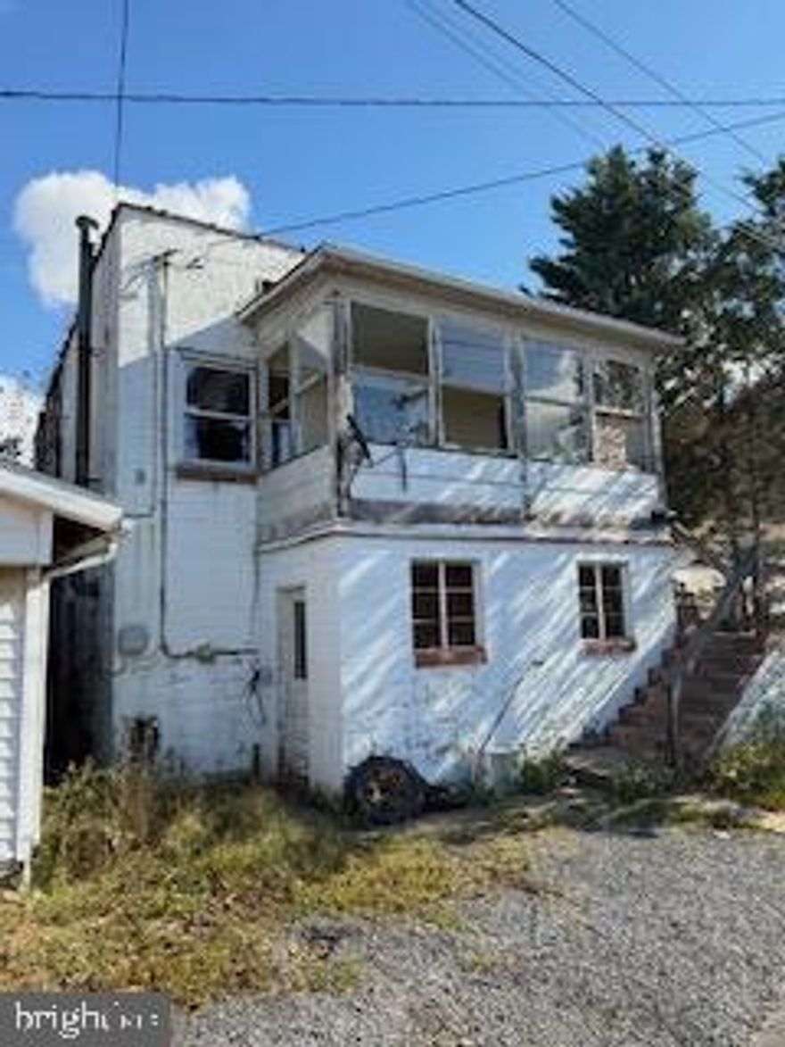 ATTENTION INVESTORS!  TOTAL BLOCK 2-STORY GARAGE WITH OVERHEAD 2 BEDROOM, 1 BATH APARTMENT IN NEED OF COMPLETE REMODEL. SIDE GARAGE DOOR. CORNER LOT. METAL ROOF.  LOW WV TAXES. PROPERTY TO BE SOLD "AS-IS" CONDITION.