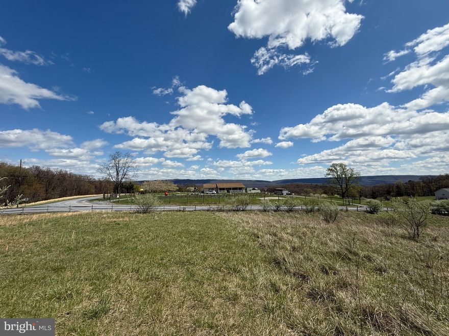 Discover the perfect blend of tranquility and convenience with this stunning 5-acre homesite nestled in a scenic mountain community. This mostly cleared lot offers a peaceful setting with mature trees lining the northern border for added privacy, while a small wet weather pond adds natural charm. The property’s gentle upward slope maximizes the breathtaking panoramic mountain views, creating the ideal backdrop for your dream home or vacation retreat. Located just 21 miles from Winchester, VA, 13 miles to Inwood, and only 18 miles to Martinsburg, this property offers rural serenity without sacrificing accessibility. Enjoy premium community amenities including a catch-and-release fishing pond, charming gazebo, picnic area with BBQ grill, and private access to Sleepy Creek Wildlife Management via a scenic path from Cressida Drive. Whether you're looking to build now or invest for the future, this is your opportunity to own a slice of West Virginia paradise. Schedule your tour today and take the first step toward making this incredible property yours!