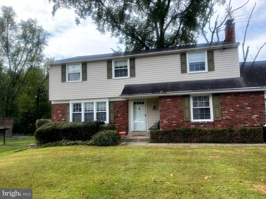 Come and See this Spacious 4- Bedroom, 2 -1/2 Bath Corner Colonial in Desirable Buckridge Neighborhood!  Lovely front lawn, covered entry door, Bridge behind property redone by Township, as well as new concrete at side sidewalk; Step into bright foyer, living room and formal dining room have hardwood floors, Thru-wall A/c in dining room; spacious eat-in-kitchen w/lots of white cabinets, tiled backsplash, recessed lights, Dishwasher, New G/D;  There's a large 1st floor family room w/wood-burning fireplace, (not recently used), crown molding, 2 closets - French doors to airy, huge wrought-iron fenced patio for relaxation with your morning beverage! Convenient 1/2 bath w/vanity sink, toilet replaced; Laundry includes newer washer; dryer, shelving, laundry tub; Exit to rear; Steel door provides inside access to front garage, pull-down attic for additional storage, workbench; Upstairs the large main bedroom has 2 windows, there are hardwood floors under w/w carpet, great walk-in lighted closet! Full master bath has new toilet - vanity sink, stall shower - The  full hall bath has tub w/showerhead, toilet replaced;  2nd bedroom w/ceiling fan, roomy closet, hardwood floors, Linen closet; 3rd Bedroom has 2 windows, generous double closet; Nice-sized Bedroom 4 also has 2 windows and roomy double closet;  Downstairs is full unfinished basement - French drain, sump pump - Weil McClain Gas H/W Heat (2024), 2-Zoned, Gas h/w.  Great Residential Area, Accessible to Shopping, Restaurants, Nature!  Flood Insurance is Required (Quote Available)