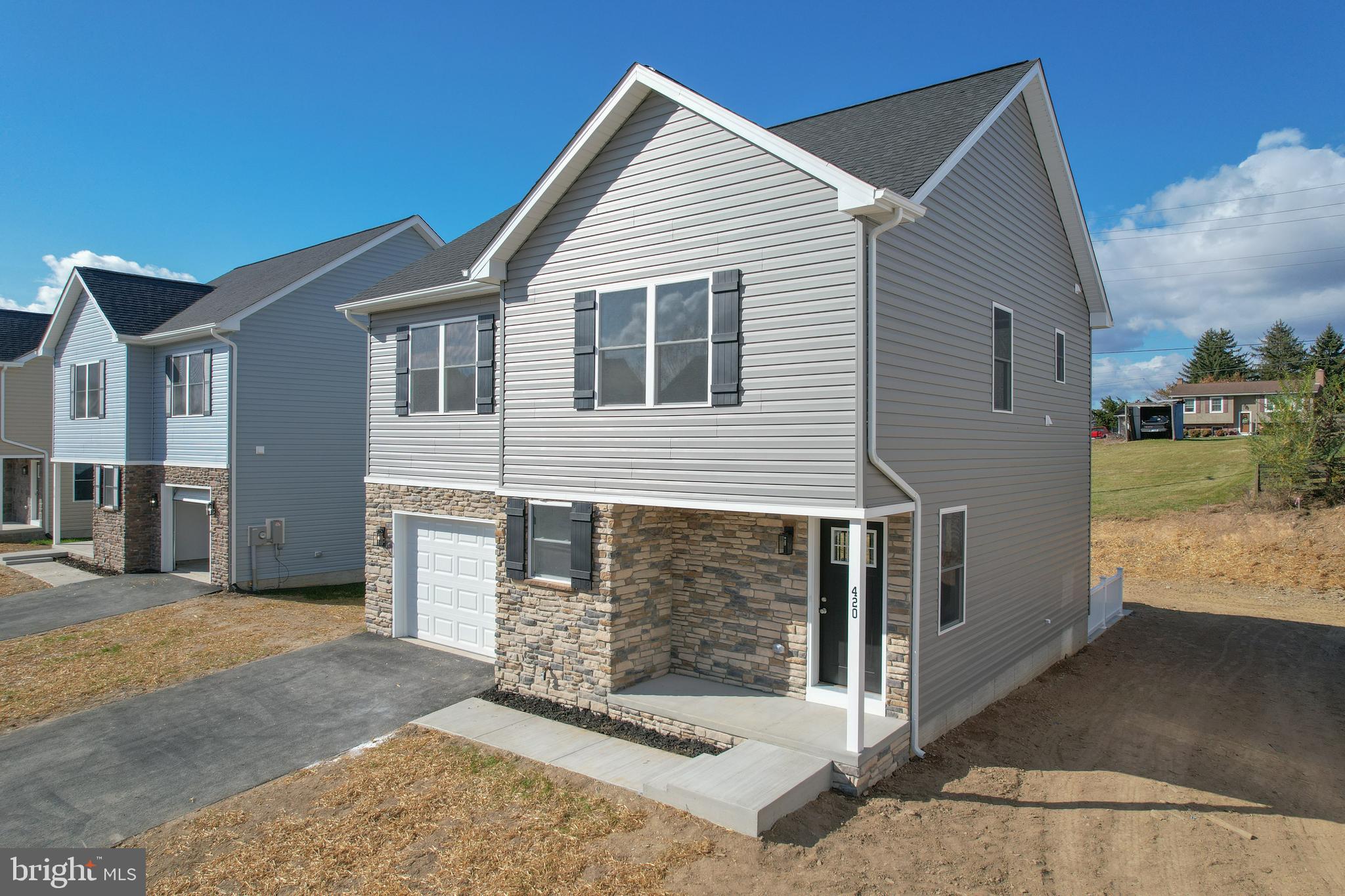 IMMEDIATE DELIVERY!!!!! Make brand new home ownership a reality! Tucked away on the edge of town, with NO HOA you'll find this gem! 3 bed, 2.5 bath new construction home with full basement and attached garage. Home is finished with luxury vinyl plank flooring on main level, stainless steel appliances, upgraded countertops, and upstairs laundry area. The primary suite features a walk in closet, double bowl sinks, and tiled shower. Public water and sewer, paved road, driveway, and sidewalk.