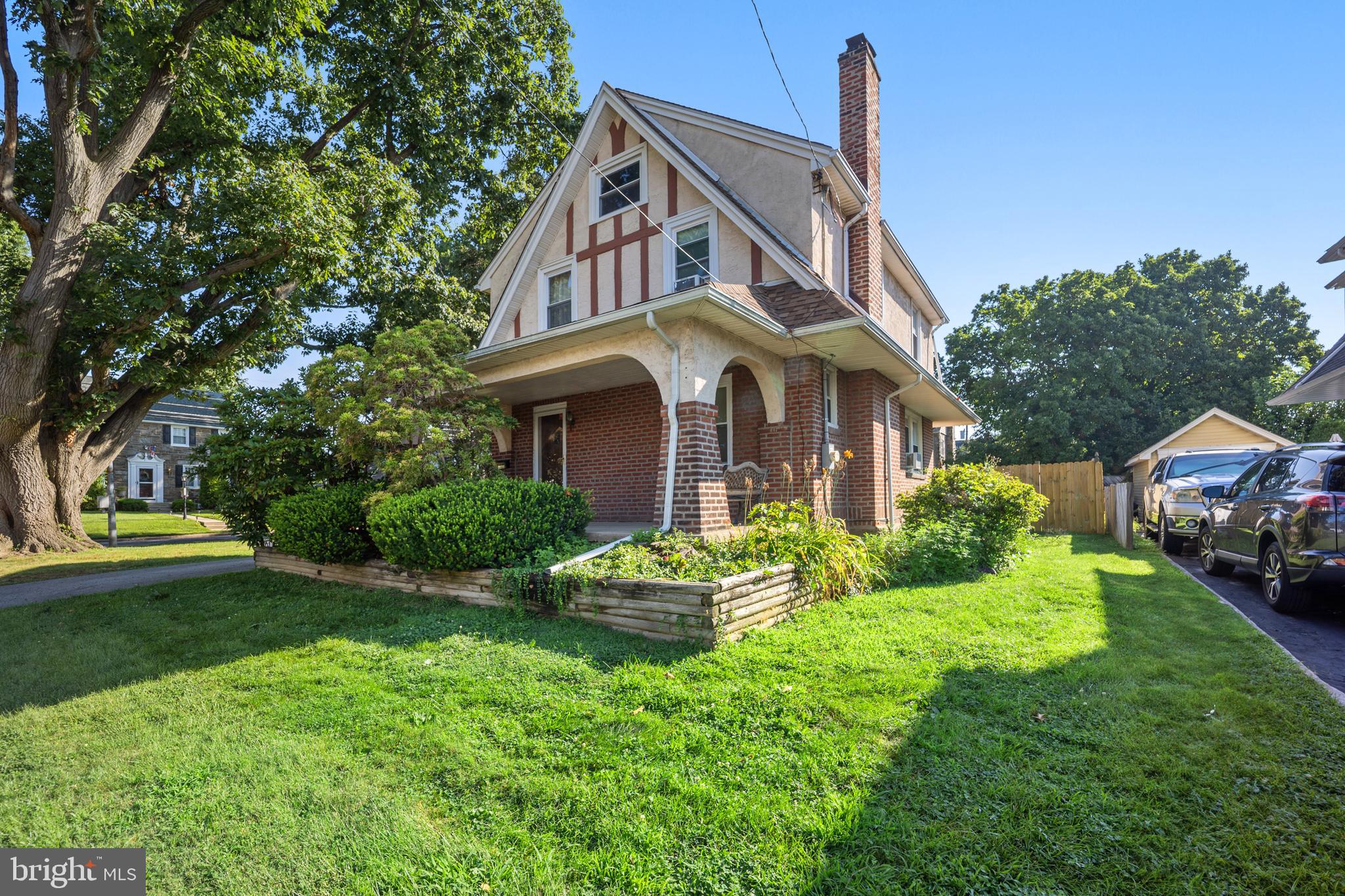 Charming 1929 Tudor in Drexel Hill – Timeless Character Meets Modern Comfort
Welcome to this charming 3-bedroom, 1.5-bath Tudor-style home offering 1,760 square feet of inviting living space. Nestled on a picturesque corner lot in desirable Drexel Hill, this home is framed by mature Oak and Pine trees, vibrant azalea shrubs, and timeless architectural charm.
Step inside to discover gorgeous original hardwood floors and classic woodwork throughout. The living room features a wood-burning fireplace, lighted ceiling fan, and brand-new windows that flood the space with natural light. The formal dining area flows seamlessly into a spacious kitchen, which boasts upgraded counters, a gas stove, tile backsplash, and direct access to a large deck to the backyard—perfect for outdoor dining and entertaining.
Upstairs, you’ll find three comfortable bedrooms, a full bath, and a bonus room ideal for a home office or guest space. A full walk-up attic provides abundant storage or potential for additional 4th bedroom/living space. The home also includes a convenient powder room in the basement.
Outside, enjoy a private, fenced backyard oasis with ample room for play and relaxation. A detached 1-car garage and extended driveway offer parking for up to 4 + vehicles.
With its blend of classic Tudor elegance and thoughtful modern updates, this home is ready to welcome its new owners.. Don’t miss the opportunity to own this lovely piece of Drexel Hill history!