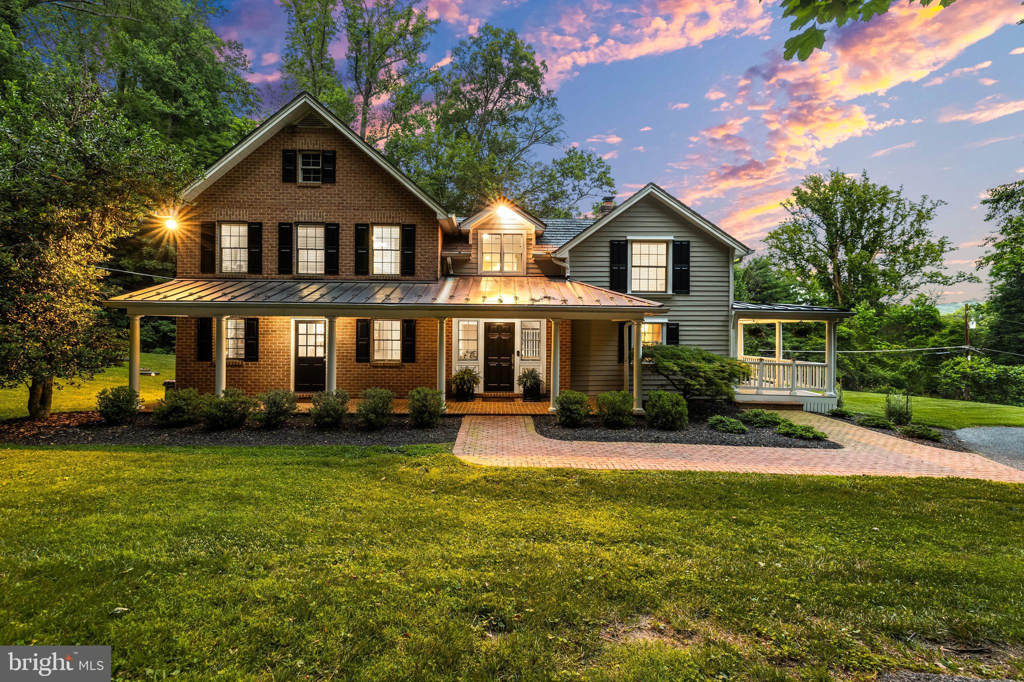 Nestled amidst the verdant, rolling hills of Greenspring Valley, 2628 Greenspring Valley Road stands as a serene sanctuary, blending timeless charm with modern sophistication in one of Maryland's most coveted enclaves. This private retreat, perched on a lush 0.6-acre lot, offers an escape from the bustle of everyday life, enveloped by mature landscaping that enhances its sense of seclusion and tranquility. Imagine mornings spent on the expansive wraparound porch—measuring an impressive 40 feet by 38 feet—sipping coffee as the sun filters through the trees, or evenings unwinding with views of the valley's gentle slopes. Recent exterior updates, including a complete porch rebuild in 2019 with fresh flooring, newly painted shutters & siding in 2022, and thoughtful landscaping enhancements from 2017 to 2024, ensure this outdoor haven is as functional as it is inviting, perfect for al fresco gatherings or quiet reflection in a peaceful, nature-embraced setting.
Step inside to discover a main level designed for seamless flow, where spacious, flexible rooms transition effortlessly from intimate daily living to grand entertaining. Bathed in abundant natural light streaming through generous windows, the open layout connects the living areas with grace, creating an airy ambiance that feels both welcoming and expansive. Stylish updates abound, from the freshly painted interiors in 2017 to contemporary appliances—like the 2024 dishwasher and microwave— that elevate the kitchen's appeal for culinary adventures or hosting soirées. Two cozy fireplaces anchor the spaces, one in the inviting family room and another in the formal living area, adding warmth and character for gatherings around the hearth, whether it's a casual family movie night or an elegant dinner party with friends.
Upstairs, the allure continues with four generously sized bedrooms, including a primary suite boasting a spa-like bath, three additional bedrooms plus two more full baths. Throughout, the home's thoughtful renovations—such as a new water softening system in 2022, updated chimneys with fresh caps and flashing in 2017, and a new well water tank in 2019—ensure modern comfort without sacrificing its inherent elegance. This Greenspring Valley gem isn't just a house; it's a canvas for life's most cherished moments, where natural light dances across updated surfaces, privacy reigns supreme, and every detail invites you to create lasting memories in a setting that feels worlds away yet conveniently close to Baltimore's vibrancy.