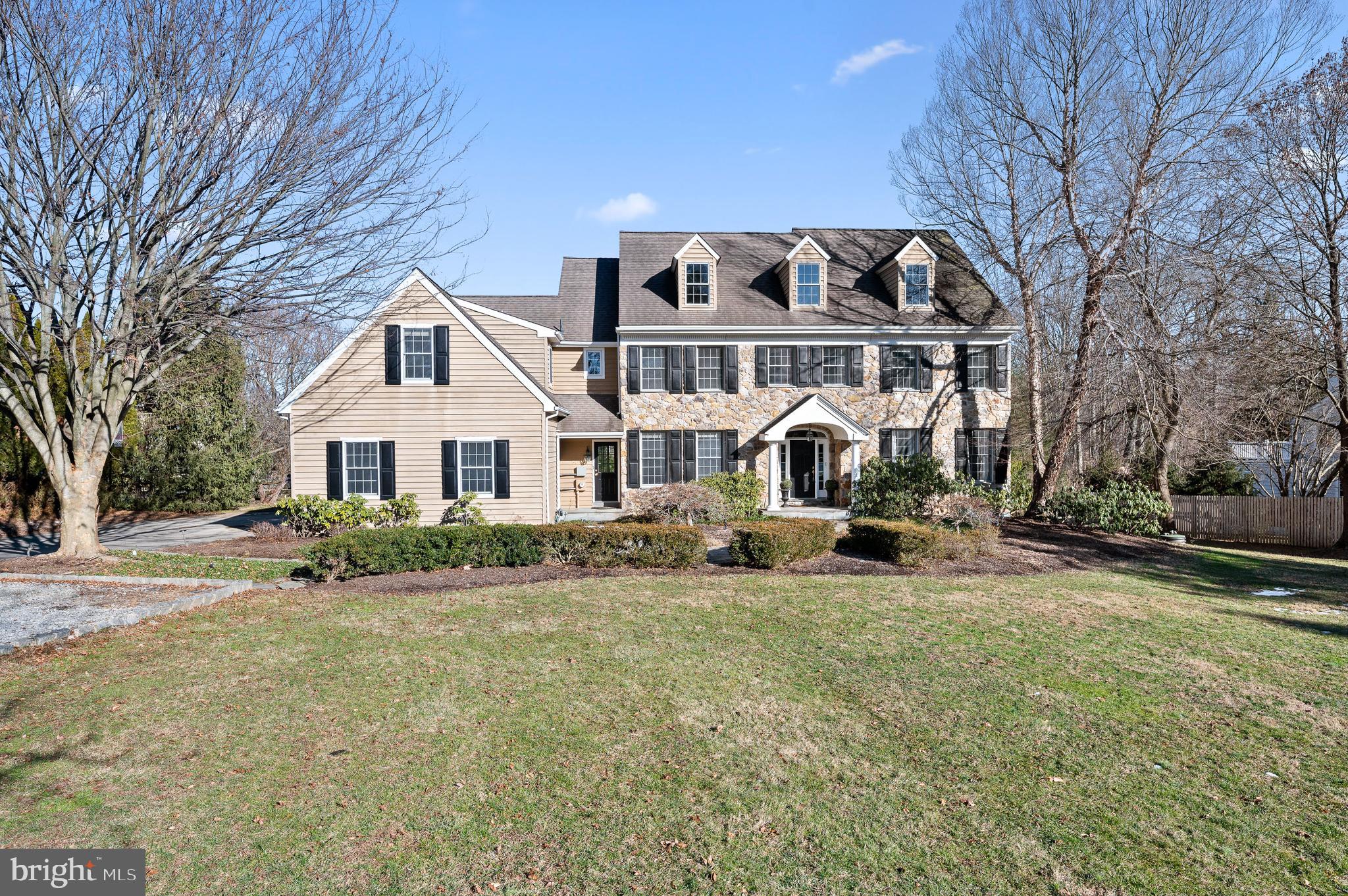 Stunning Stone Colonial set back on a private level almost 2 acre lot in Tredyffrin/Easttown School District! This custom decorated home offers elegant and versatile spaces on three floors, multiple patios and a huge fenced in yard! Enter through the grand foyer and you are welcomed by warm hardwoods, a stunning staircase and an abundance of natural light. The formal living room and office with custom wallpaper treatment are both off of the foyer and offer flexible space for working and entertaining. The kitchen is a chef’s dream with a large seated island, stainless appliances, granite counters and white cabinetry open to the breakfast room and great room. A Thermador gas range, professional hood, oven warming drawer and microwave, Bosch Dishwasher and Sub Zero Refrigerator make cooking in this kitchen anything but a chore! A butler's pantry offers additional storage, a wet bar and desk area which lead to the large formal dining room. The dining area has glass sliding doors to the flagstone patio, perfect for indoor/outdoor entertaining and is open to the great room. The large great room features a gas fireplace and vaulted ceilings. The mud room was recently remodeled to create the ultimate organized entrance, with bench seating, six custom cubbies, a desk area, and ample closet storage! A powder room with grasscloth wallpaper and entrance to the garage complete this covetable space! A formal power room, back staircase and second front entry space plumbed for a wet bar round out the first floor. The oversized primary bedroom suite is located at the top of the stairs. With a large bedroom, views of the expansive and scenic yard below, remodeled bathroom and an absolutely huge closet this suite will delight! The sumptuous primary bath features custom cabinetry, granite counters, double sinks, a dressing area, clawfoot soaking tub and frameless glass shower complete with rain shower head, and body sprays for a spa like shower experience. The oversized walk in custom closet has an island for storage, built in shelving and drawers for all of your storage needs. Bedroom #2 is large with a double door closet and utilizes the recently remodeled hall bath with white vanity, tub/shower combo Carrara Marble subway tile and Carrara flooring. Bedrooms 3&4 are both spacious one with a walk-in closet and share a jack and jill bathroom with designer wallpaper, navy vanity and shower tub combo with neutral tile. Bedroom 5 has a double door closet and utilizes a second hall bath with stall shower with a single vanity and neutral tile. The Laundry room is also on this floor with built-in cabinetry, hanging rack and sink! The Walk-Out Lower Level is truly an extension of this home with multiple full size daylit windows making the space light and bright. There is an open space perfect for a media room, exercise room or entertainment area. A wet bar & patio allows for seamless entertaining. A bedroom and full bathroom complete this level and could be used as a home office if needed. Plenty of storage space too! Outside the 1.8 acres allow for privacy as you are well set back from the street and an amazing level back yard is great space for a soccer or lacrosse game. Two flagstone patios offer multiple dining spaces for al fresco dining in the warmer months ahead! All of this located in Award Winning T/E Schools and convenient to major highways and transportation!