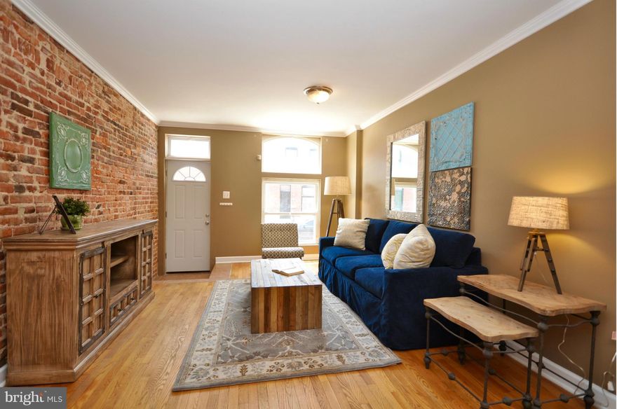Lovely starter home in the Highlandtown Arts District. Enjoy strolling to Patterson Park, galleries, studio tours, farmers markets & events such as the H-town Wine Festival & Bsmt Bar Tour. Wood floors, 110-year old exposed brick, tin ceilings & the original banister hearken back to the early 20th century. Open main level layout. 2 BRs upstairs w/center FB. Improved LL w/flush. Fully fenced patio.