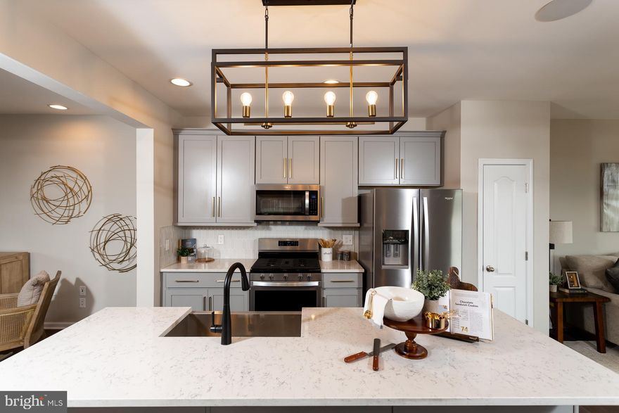 *OFFERING UP TO 10K IN CLOSING ASSISTANCE FOR PRIMARY RESIDENCE WITH USE OF PREFERRED LENDER AND TITLE.*
December Delivery! Come home to Berkeley County’s premier planned community featuring a clubhouse, swimming pools, walking trails, lush landscaping and mountain views. The Darlington II with stunning elevation 9 with a double box bay window and stone water table, 3 level townhome with 1 car garage featuring 3 Bedrooms and 3.5 Baths. The covered front porch leads directly through the front door into the spacious lower level including 9 ft. ceilings, foyer with a double coat closet, access to the garage continuing into the fully finished lower level recreation room with full bath and walkout access to rear yard with privacy fencing. This home features a 3 level morning room extension and oak staircases throughout. Open concept main level with 9 ft. ceilings, luxury vinyl plank flooring throughout this level, dining room and kitchen with stainless appliances, large 8’ plus island, upgraded level 2 kitchen cabinets & quartz countertops, that leads directly into living room with powder room. The primary suite includes a tray ceiling and large walk-in closet. The primary bathroom includes a vanity, tiled shower with seat and separate soaking tub. Laundry is located on the bedroom level. Home and community information, including pricing, included features, terms, conditions, availability and sales procedures related to appointments subject to change without notice. All images are for illustrative purposes only and individual homes, amenities, features, and views may differ. Images may be subject to copyright.