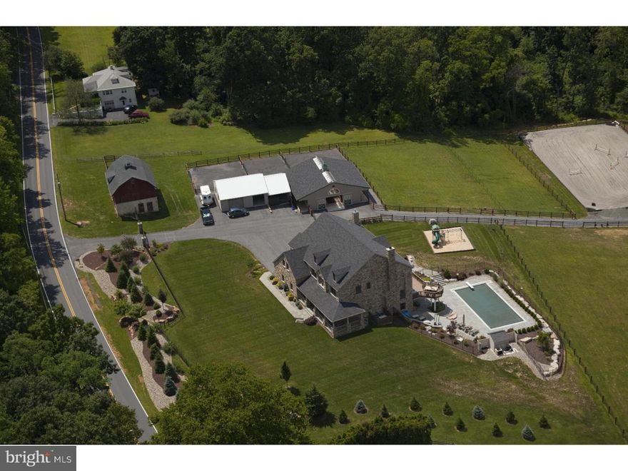 WOW!! This stunning property features some of the best long distance views in all of the Lehigh Valley!! THE CUSTOM BUILT HOME BOASTS SUPERIOR AMENITIES INCLUDING A SPARKLING SWIMMING POOL, PATIOS, GARDENS AND OUTBUILDINGS  EMBRACED BY 10.4 ACRES IN THE EAST PENN SCHOOL DISTRICT AND IS MINUTES FROM LV HOSPITAL AND THE BOROUGH OF EMMAUS.  Granite countertops, a massive center island & hearth room with fireplace accent the gourmet kitchen. Anchored by a  second fireplace, the 2-story great room overlooks outdoor entertaining space with scenic vistas for miles. There are 4 brs, including a master suite with luxurious bath, a second kitchen, exercise room, changing area & full bath in the walkout lower level, 6-car garaging w/cabinets & organizers and two barns in impeccable condition for heavy equipment, automobiles, or livestock. Not just for the horse enthusiast, this property is an incredible opportunity to own an estate home with flexible options!!