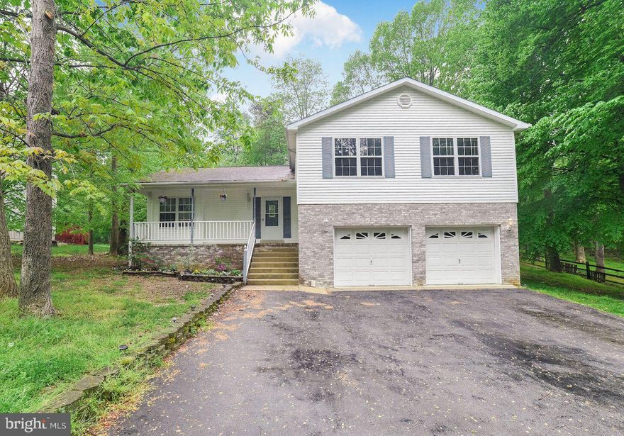 Beautiful home with gigantic master bedroom and walk-in closet on a quiet street.  Spacious floorplan with gorgeous hardwood flooring throughout dining area, opening into living room.  Newly remodeled kitchen with granite countertops and eat-in breakfast nook. Finished basement with fireplace can be used as family or recreation area. The two car garage with paved driveway provides plenty of parking space.  The front porch makes for a perfect area to put a bistro table to enjoy your morning coffee, looking out over the landscaped flowerbeds.  In the back, two sliding glass doors open to a massive deck that provides a quiet oasis overlooking the backyard.