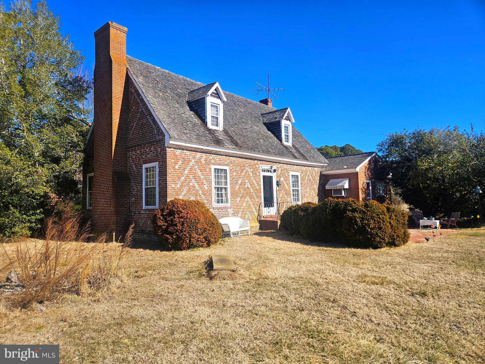 Step into the heart of Worcester County’s rich heritage with the Fassitt House, the oldest continuously inhabited home in its original condition. This remarkable property, a proud member of the National Register of Historic Places, was built in 1730 and showcases the timeless beauty of Georgian architecture. The home’s iconic Flemish Bond brick checkerboard pattern is a testament to craftsmanship from an era long past. This property comes with 29 years of permitted use remaining of a 45' dock at the marina adjacent to the property.
Inside, the residence retains its original character, with stunning hand-carved raised panel wainscoting and intricate trimwork, along with plank floors and ceilings that tell stories of centuries gone by. The formal dining room is a standout feature, boasting the original woodwork and a unique corner cabinet from the historic Riddle Farm. The stairway, thoughtfully upgraded in the late 1700s, now features Federal Style embellishments and a beautifully hand-carved railing and newel post—design elements also found in the celebrated Henry’s Grove, another cherished historic home just down the 611 corridor.
This home’s connection to history is profound. It stands proudly on Sinepuxent Bay, where it endured a cannonball strike during the War of 1812—a vivid reminder of the turbulent times it has weathered. For nearly 300 years, the Fassitt House has been home to the same family, an enduring legacy of tradition and preservation. A major renovation in 1950 ensured the home’s survival, with care taken to maintain its historic integrity. The addition of a “modern” kitchen at the time has since become historic in its own right, seamlessly blending the old with the new.
The 50-acre property also houses two original outbuildings—a smokehouse and a corncrib—that further enrich the home’s legacy. The Fassitt House is not just a home; it is a living piece of history, and this is a rare and significant opportunity to own a piece of Worcester County's past.