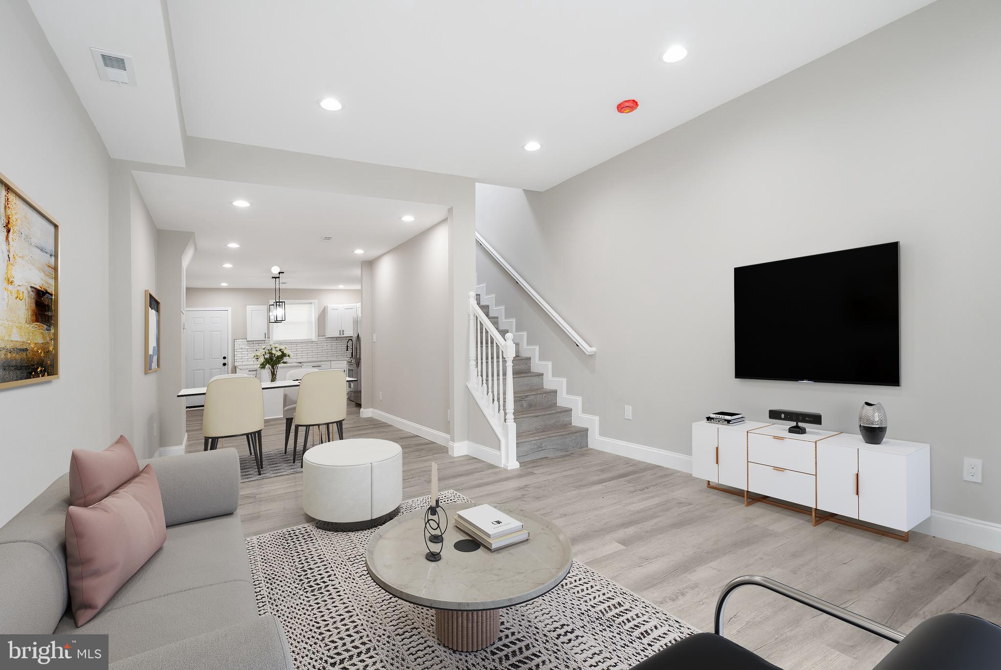 Welcome to this fully renovated rowhome where every inch has been thoughtfully updated! As you enter, you're greeted by sleek LVP flooring and an open floor plan illuminated by recessed lighting. The living room, flooded with natural light, is perfect for entertaining guests. The dining area flows seamlessly into the chef’s dream kitchen, featuring an island with bar seating, ample cabinetry, a tile backsplash, stainless steel appliances, and stunning quartz countertops. Upstairs, the spacious and bright primary ensuite offers a generous closet and a bathroom with a custom tile surround tub/shower combo. The second bedroom provides direct access to the second-floor deck—ideal for morning coffee or evening relaxation. An additional full hallway bathroom makes hosting guests a breeze. For added convenience, the laundry area is also located on the upper level. The lower level is ready for your personal finishing touches, providing endless possibilities. Outside, enjoy summer BBQs on the second-floor deck or the fully fenced-in patio. Conveniently located near Rt 40, Belair Road, Johns Hopkins Hospital, and Clifton Park, this home is a true gem. Don’t miss out—schedule your showing today!