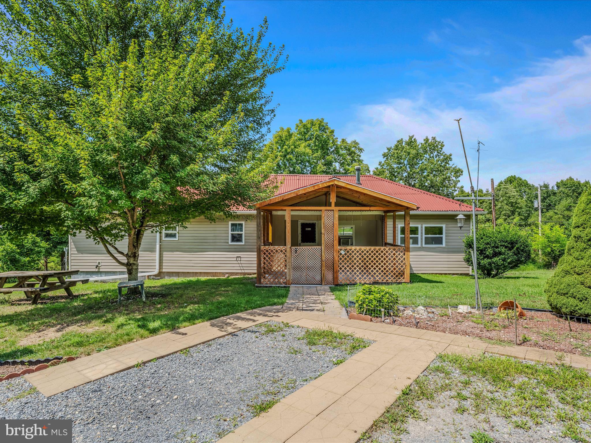 5.90 acres with a home on a private road and private setting. Home features 2 full baths and two bedrooms. An extra space for an office is a plus. Separate dining room, kitchen, and living room with a wood stove. A detached garage and an added storage building are included. A nice covered porch for enjoying the outdoors.