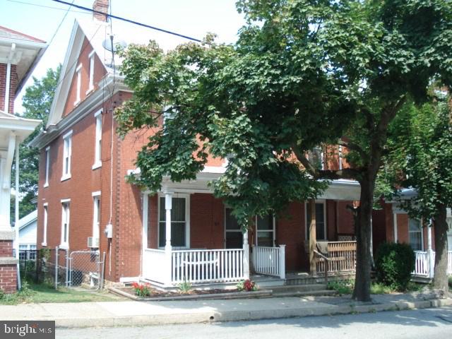 Beautiful brick 3 bdrm semi accented w/ gorgeous hardwood floors, custom designed columns; natural woodwork thru-out. New kit w/ island & pantry. Spacious lr/dr w/ coffered beamed ceiling; new bath; new 200 elec and plumbing. New windows, insulation & much more. 2 covered porches including porch swing; fenced yard & 1 car gar w/ wk-shop. Close to park and pool. A must see. 100% financing to qualified buyers. A great place to call home - no more rent.