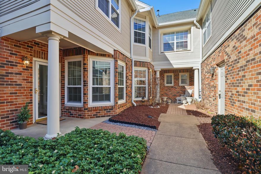 Stunning, move-in ready two-level Town Home in the highly desirable Chelsea Court, just minutes from the vibrant One Loudoun Lifestyle. This charming and bright home features 2 spacious bedrooms, each with a full ensuite and XL walk-in closet. The spacious master suite includes stunning wall of windows and vaulted ceilings. Enjoy coffee on your adjoining, private outdoor patio. A convenient half bath and front-load laundry are located on the main level. The pristine white kitchen boasts granite counters and an eat-in morning room overlooking the front garden and offering extra storage. A sliding glass door off the dining room leads to the back patio, with additional natural light from a skylight on the staircase. Enjoy the convenience of an oversized, detached 1-car garage with custom built-in cabinetry and extra storage just steps away from your front door.

High-end details include upgraded crown molding, chair railing, window framing, and wooden horizontal blinds. The second bedroom is ready for a possible office option with built-in solid custom cabinetry. Perfect for commuters with quick access to major routes, this home offers low-maintenance living with easy access to shopping, dining, and entertainment. A flawless blend of style and convenience—don't miss out on this incredible opportunity!

Recent Updates Include: 2025: Fresh Interior Paint, Brushed Nickel Lighting & Fixtures; 2024: New Fireplace Pilot, Starter, Fan & Logs; 2022: New Energy Efficient Windows and Custom Wooden Window Treatments, Hot Water Heater, HVAC (LEEDS rated), Refrigerator, Sliding Glass Door & Frame, Bathroom Ceiling Fans 2020: New Roof; 2019: Skylight Seals and Flashing.