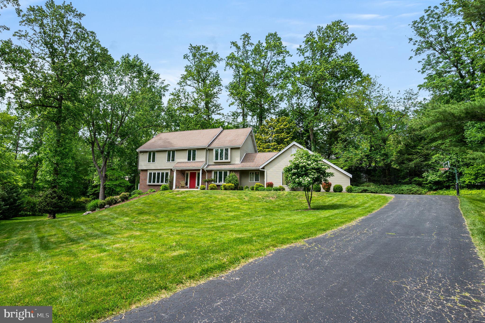 Welcome to 211 Fox Lane, Wallingford; a custom built 4- bedroom, 3.5 bath Colonial with a contemporary flare nestled on a peaceful 3/4 acre lot with lush lawns, mature trees and picturesque views from every window. Paver walkway leads you to the front porch and entry into the center hall with coat closet. To the left is a stunning Living Room with gleaming hardwood floors. To your right is the formal Dining Room with hardwood floors. Both rooms are flooded with soft light from the front bay windows with deep sills. The large Kitchen with updated appliances (included) has a great footprint with many wood cabinets, expansive counter space, pantry and Center Island. The kitchen is open to the delightful Breakfast Room that easily accommodates a large table, and has lovely windows surrounding you with deep window sills looking out to lush greenery. To the left of the kitchen you'll enter into the inviting Family Room with a wood burning fireplace, a room that says come sit and stay a while. There are sliders to a fabulous Deck, remodeled by Jack Quinlan, reminiscent of sitting in a treehouse, it's such a peaceful spot to relax at the end of the day! To the right of the breakfast room is an exit to the yard and patio. There is a convenient Powder Room, a large Laundry/Mud Room with full size newer washer & dryer (included) and interior access to an oversized two-car Garage with auto openers and a private driveway with parking for 4 + cars. The second floor Primary Bedroom ensuite has a dressing room, walk-in closet and a huge ceramic tile bath with a separate stall shower, soaking tub, double-sink vanity and linen closet. The Hall Bath with a tub / shower also has a separate double-sink vanity and serves three spacious Bedrooms each with great closet space. There is neutral paint and wall-to-wall carpet in all bedrooms, stairs and hall. Attic access is used for storage. The seller’s addition of a fully finished walkout basement Family Room is a GREAT place to hang out, watch the game, play pool (pool table is also negotiable), create your home gym, hobby or playroom, you decide! There is a full Bath with stall shower and built in shelving, a Utility Room that houses the HVAC (updated central air and natural GAS heating) and a useful under stair storage closet. Handsome laminate flooring and neutral wall to wall carpeting complete this wonderful space. This custom built home was purchased from the original owners and well-loved since 2005. The sellers are now ready to pass the keys on to buyers who will enjoy all that 211 Fox Lane has to offer. The floorplan is spacious throughout, and there’s beautiful views from every window. What a prime location on a desirable cul de sac street in the heart of Wallingford! Served by the award-winning Wallingford-Swarthmore School District, in the catchment of WES elementary, this home has it all! It is just minutes from the vibrant Borough of Media—"Everyone’s Hometown"—only 25 minutes from Center City Philadelphia, and just 10 minutes to Philadelphia International Airport. Convenient to the SEPTA rail station. Don’t miss the opportunity to make this stately custom built property your forever home!