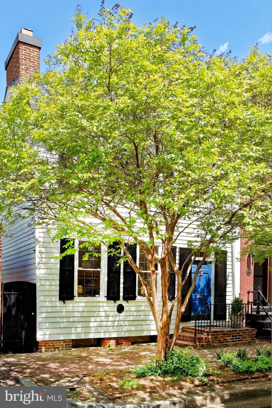 Fabulous semi-detached historic townhome, circa 1760, exudes timeless appeal with a harmonious blend of classic features and modern elegance.  3 bedrooms, 3.5 renovated marble baths, original hardwood floors, 5 wood burning fireplaces,  a side mudroom  entrance and convenient half bath with heated floors.  The open chef's kitchen with a large island flows seamlessly into the light-filled family room featuring built-in bookshelves,  a wood burning fireplace and French doors that lead to the expansive deep brick patio.  This large outdoor space is rare in Old Town.  The mature landscaping provides lush privacy and the fully fenced area is perfect for children to play plus a dog to run.  A formal living room and dining room are wonderful entertaining spaces, both filled with natural light pouring in from original windows with wavy panes of glass. The enormous primary suite with a fireplace extends across the rear of the house and overlooks the beautiful garden.  Custom built wardrobe closets with drawers, shelves and hanging space adjoins the renovated bath featuring an oversized  shower.   Two more guest rooms plus an office space are filled with windows.  Two renovated bathrooms complete these guest rooms.  The finished basement with original beams has  windows for natural light.....a perfect exercise space or playroom for children.  This prime southeast quadrant location is close to all Old Town restaurants, specialty shops and parks.    NOTE: Garden statues and urns do not convey.