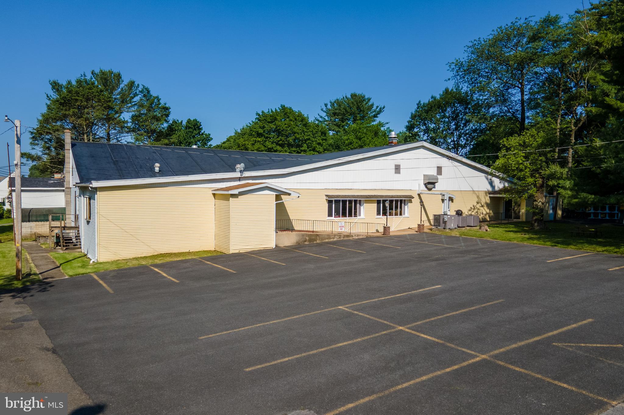 Multi-use investment property located at Pine View Acres in Pottsville, PA. This offering includes a fully operational bar and restaurant, a functional event venue, and six residential rental units across multiple parcels.
The commercial space features an indoor dining and bar area, an outdoor pavilion, and a swimming pool, allowing for a range of uses including dining service and event hosting. The main event space includes a dedicated stage and dance floor, suitable for weddings, parties, and other functions. Additionally, the lower level includes a second bar area with additional seating and a separate dance floor, providing added flexibility for hosting multiple events or expanding service capacity. The residential component includes one single-family home, one duplex, and one triplex, providing a total of six rental units. A large private parking lot serves both the residential and commercial areas. This property offers multiple income streams with both commercial and residential potential. Suitable for investors or buyers seeking a mixed-use asset with established infrastructure and flexible use space.