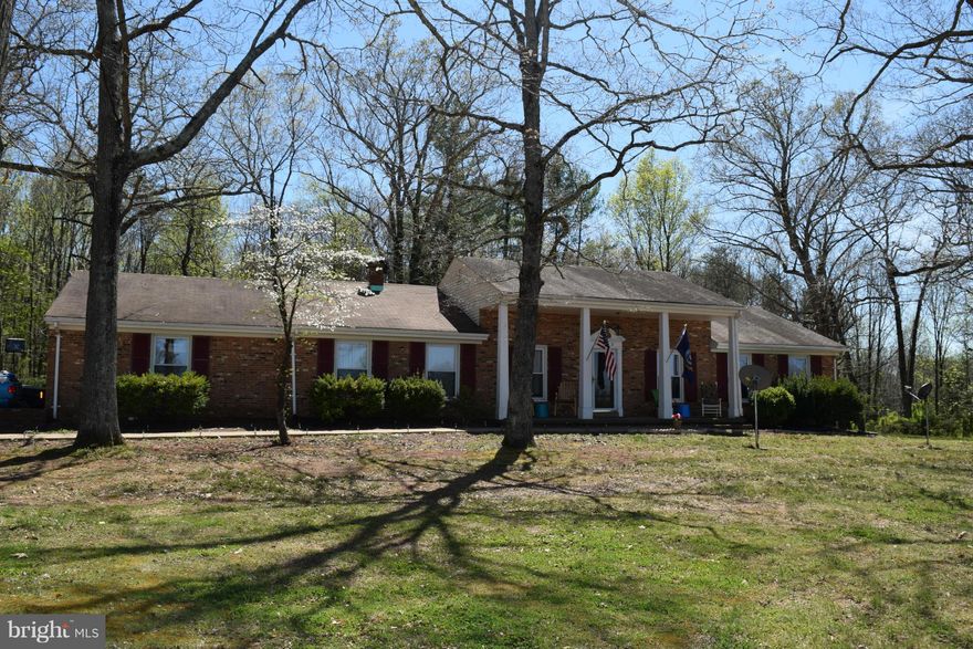 Wonderful Country Setting*Large Colonial Brick Home on 1.85 Acres w/2 Car Attached Garage*4 Nice Sized Bedrooms*Hardwood Flooring Through Out*Tile Floor in Kitchen*Finishing Off Huge Basement Has Begun and Would Make a Great In-Law Suite when Finished & Has Outside Entrance*Great Potential*Fantastic Price!!