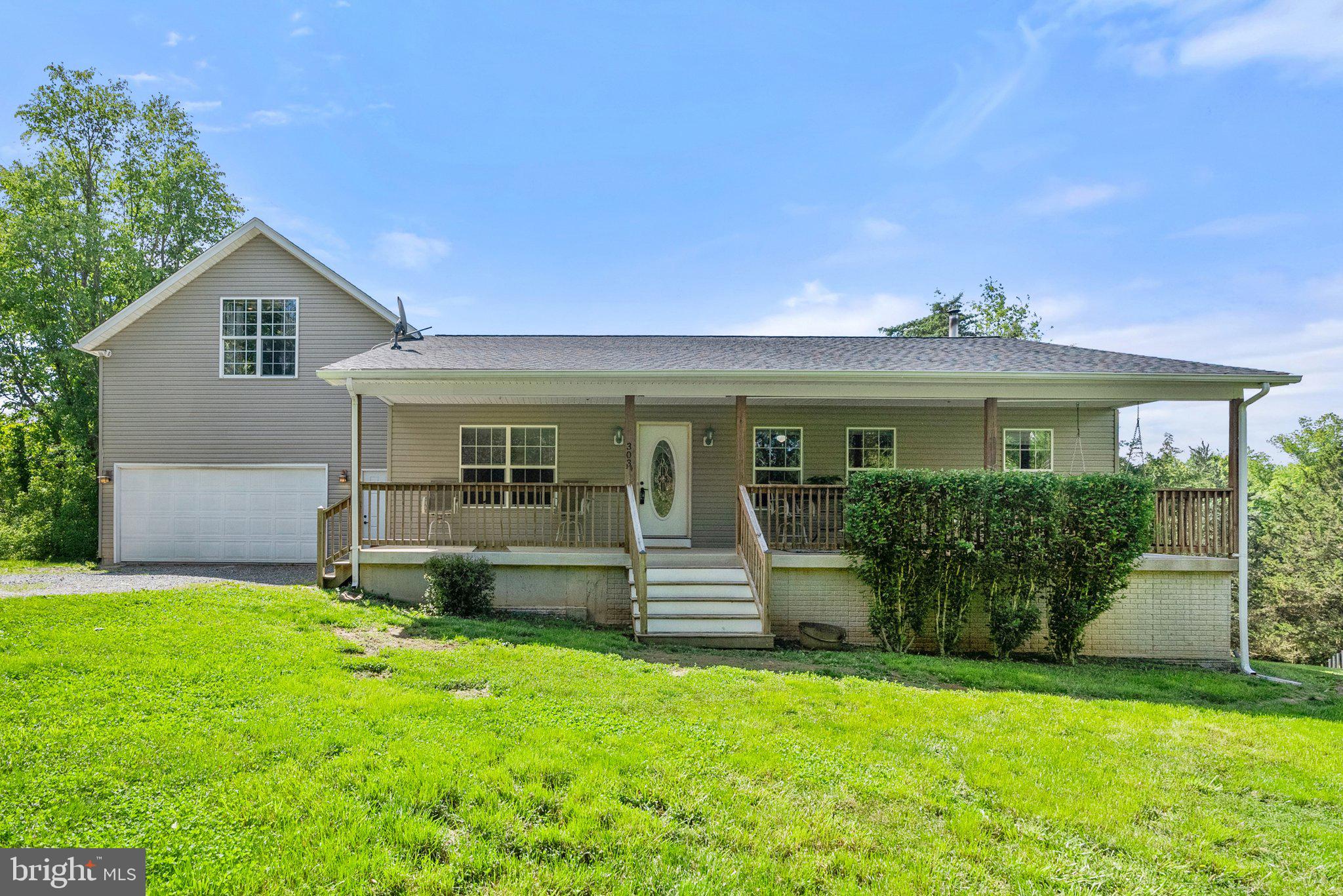 Welcome to this charming rancher in the Riverside community with river access to the Shenandoah River, offering both comfort and versatility! Enjoy 5.22 acres of community river lot with Shenandoah River access, perfect for camping, fishing, cookouts and much more! Step inside to a spacious living room with vaulted ceilings that enhance the open feel, complemented by rich wood plank accents and built-in shelving for added character and storage. Fresh paint and new flooring have been installed in most of the main living areas.
The kitchen is generously sized with plenty of counter space and a cozy breakfast nook — perfect for casual meals or morning coffee. The primary suite features a large walk-in closet and an attached bath for your private retreat. Two additional bedrooms also offer walk-in closets, ceiling fans, and share a well-appointed hall bath.
Above the two-car garage, you'll find a spacious loft — ideal for a home office, playroom, guest space or the perfect spot to start your own band (outlets in the floor make this a breeze). The lower level includes a family room with a wood-burning stove, ample storage, the potential for a fourth bedroom and a full bath, along with walk-out access to the backyard.
This home blends cozy comfort with functional spaces — a perfect fit for everyday living and entertaining.